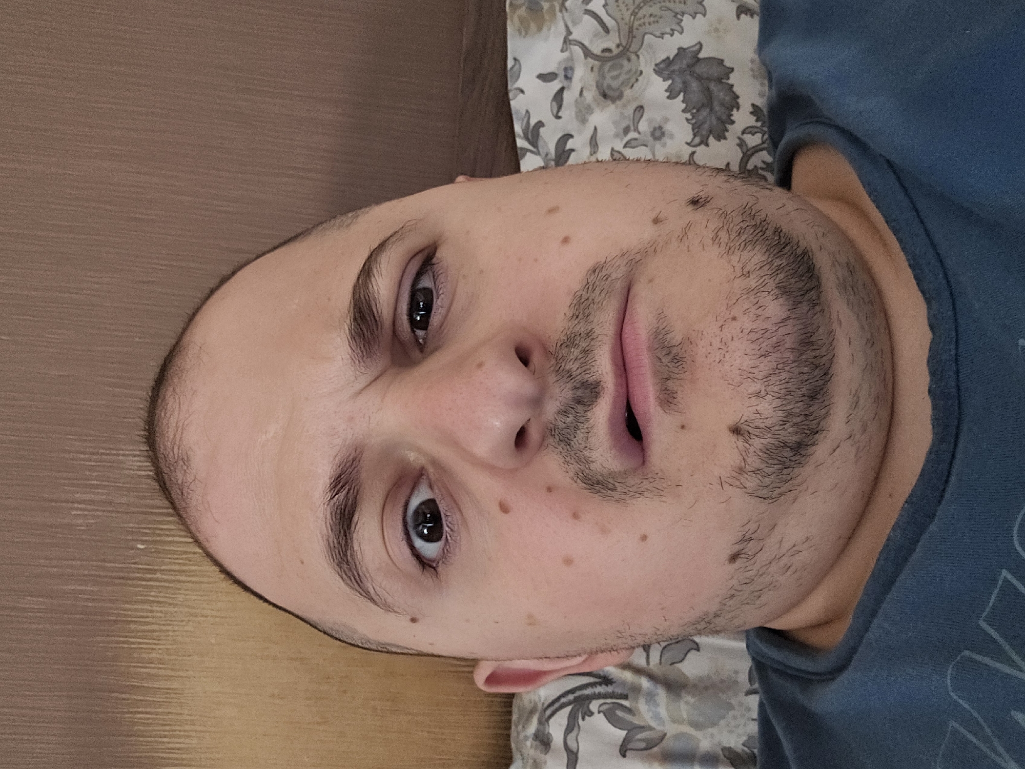 Portrait of unidentified man captured on bed