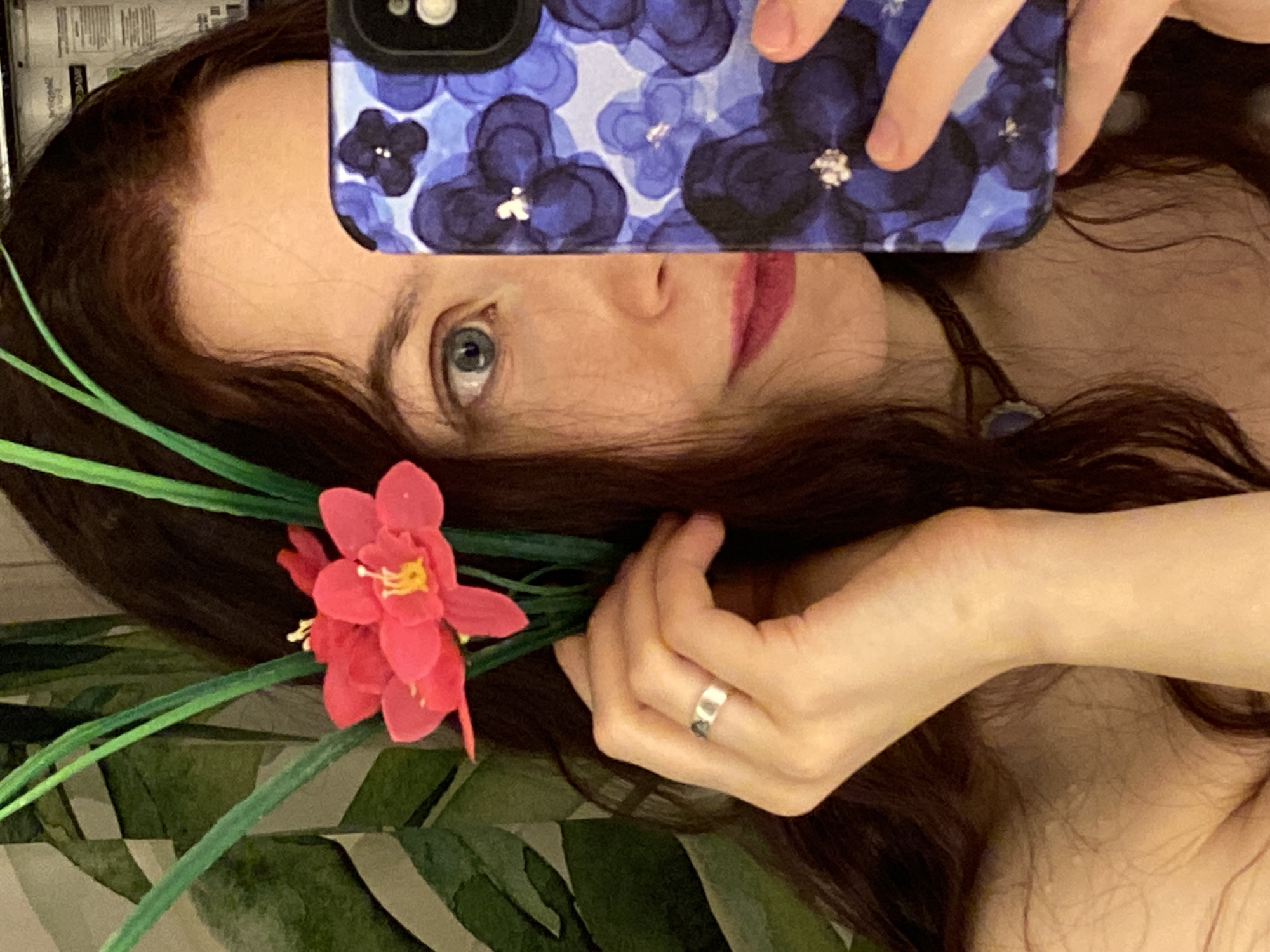 Woman poses with white flower in Chaikovsky bedroom