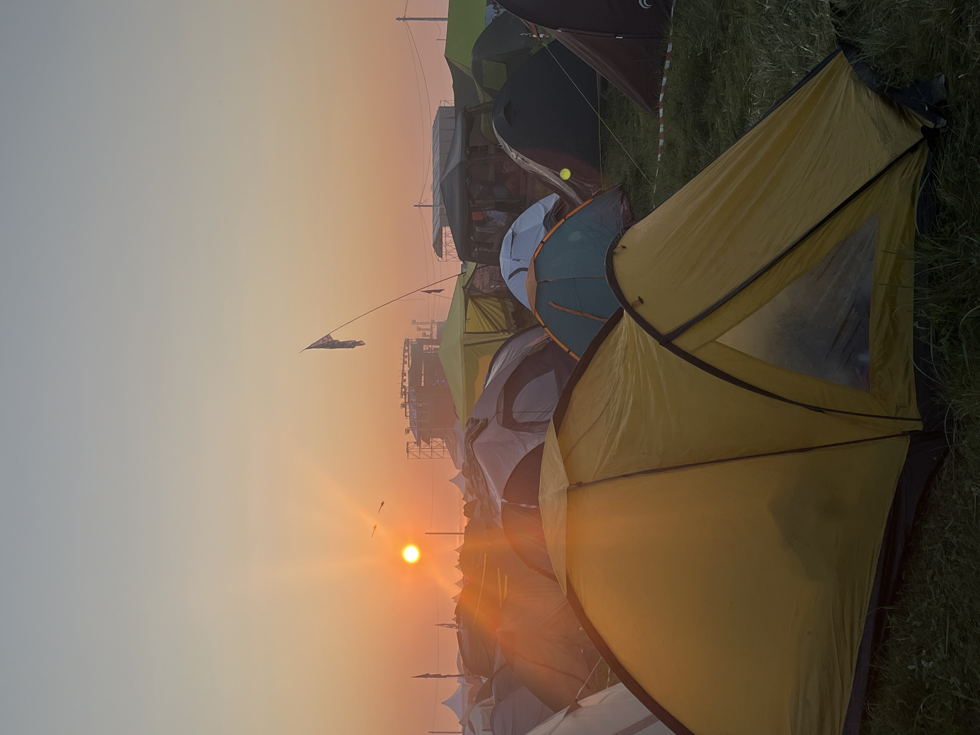 Sunrise over a tent-filled festival campground in Surakovo, Russia