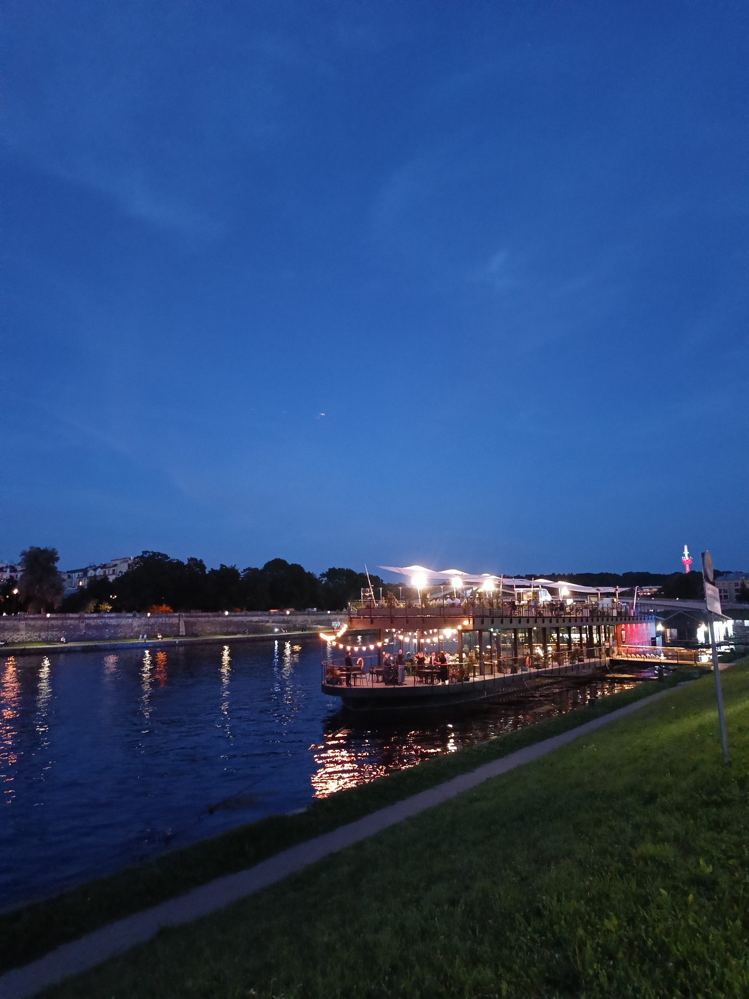 Krakow's Vistula riverfront buzzing on a summer evening
