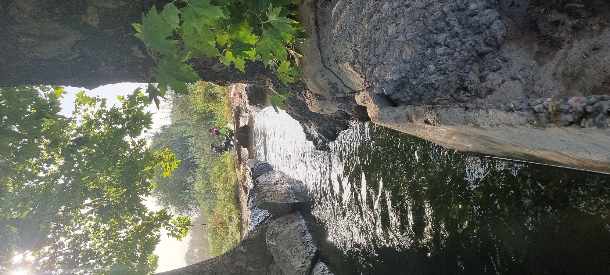 Rural life along Jomi's irrigation canals on a summer afternoon