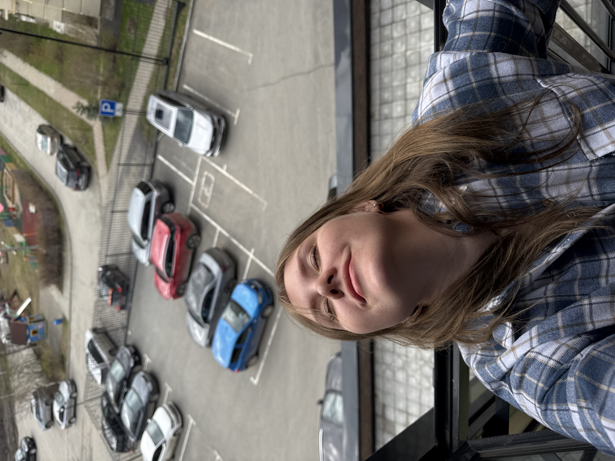 Woman leans from building window in Perm, Russia