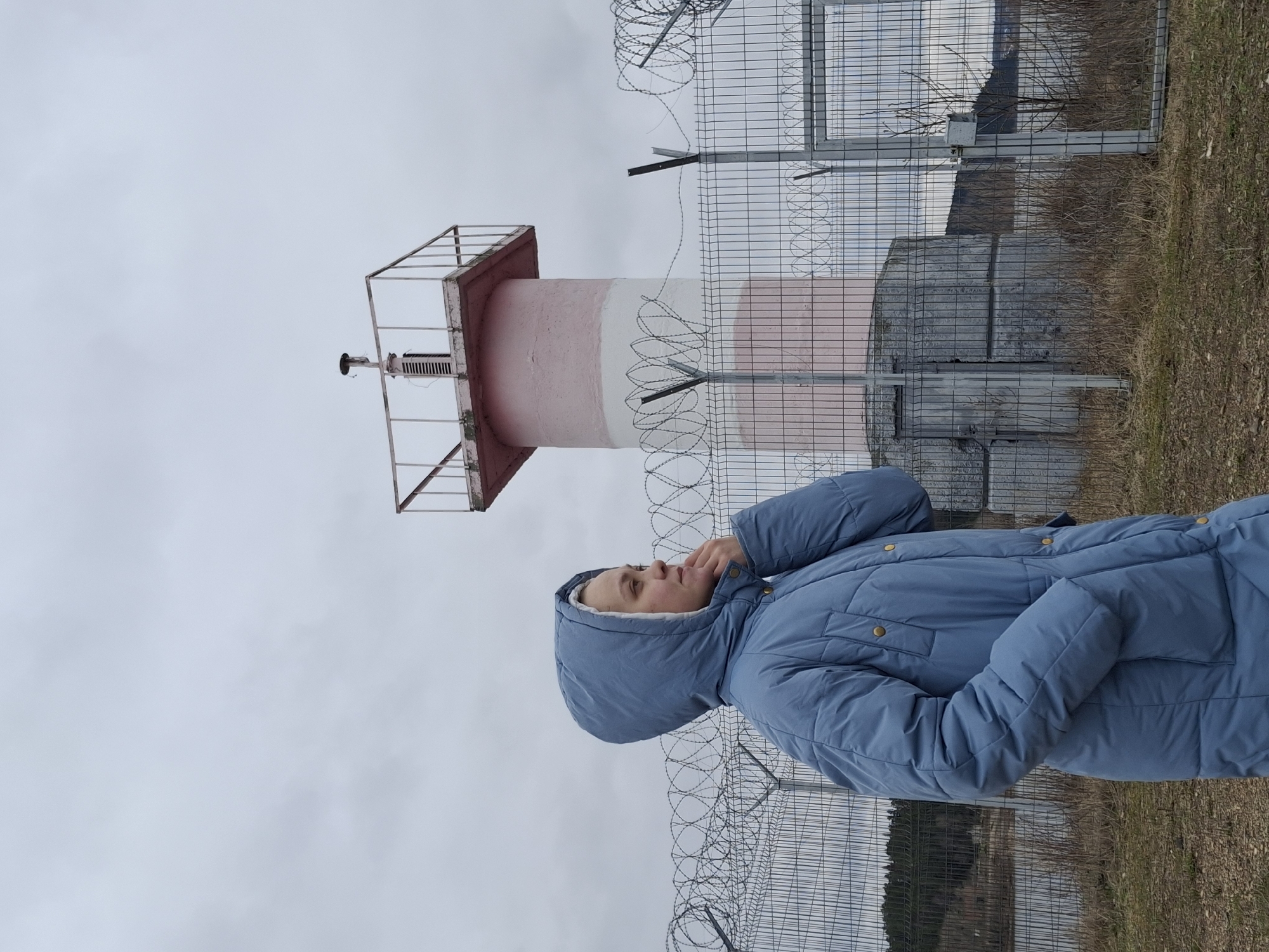 Person photographed at striped lighthouse in Chaikovsky, Russia