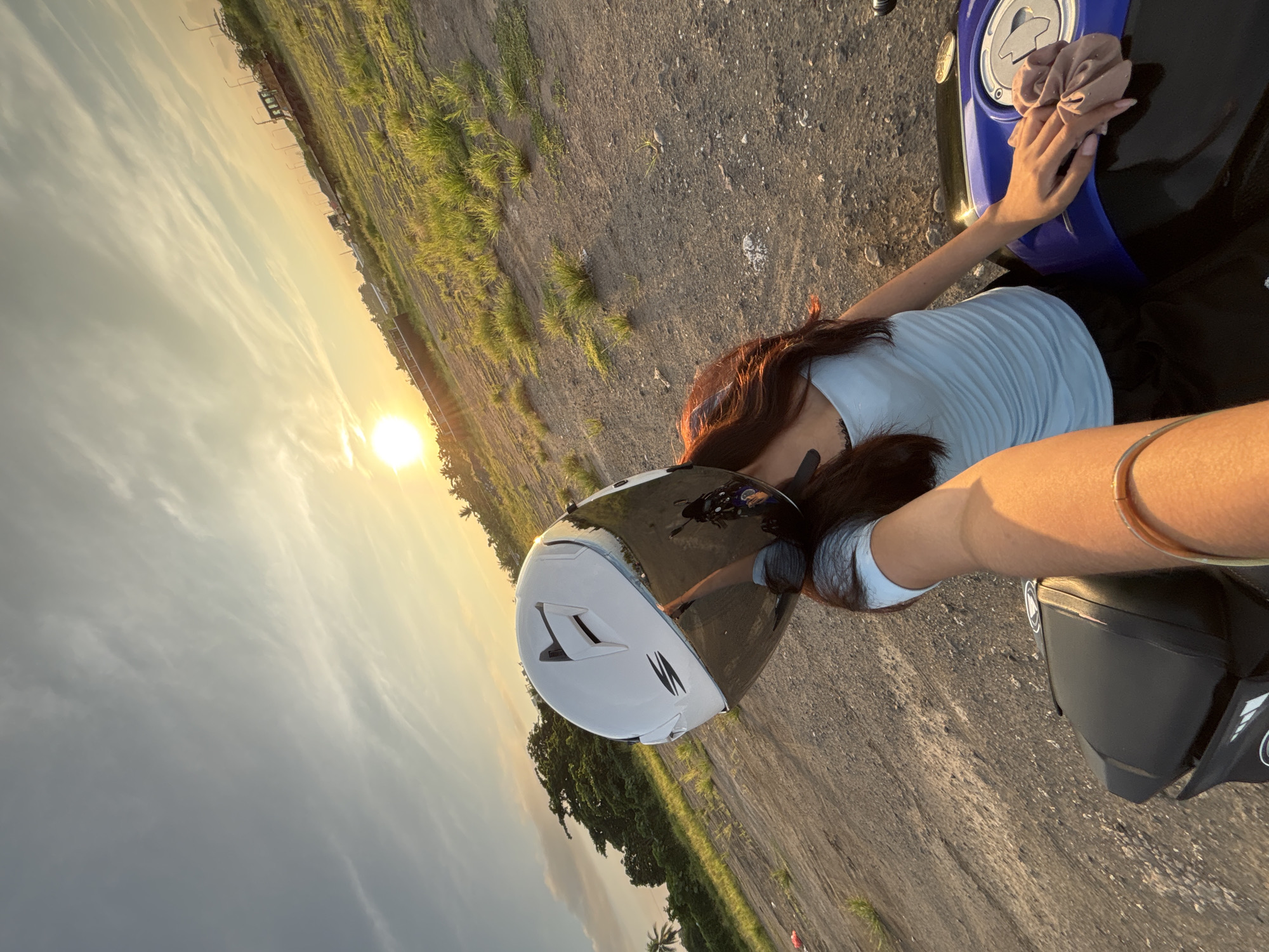 Young woman takes sunset selfies at Davao City pier