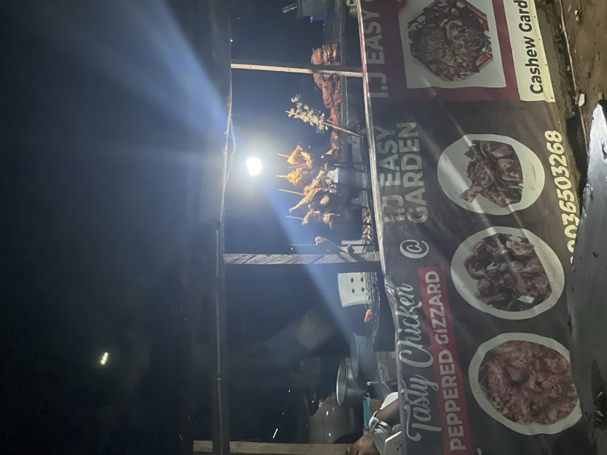 Street food vendor prepares grilled chicken sandwiches in Abuja