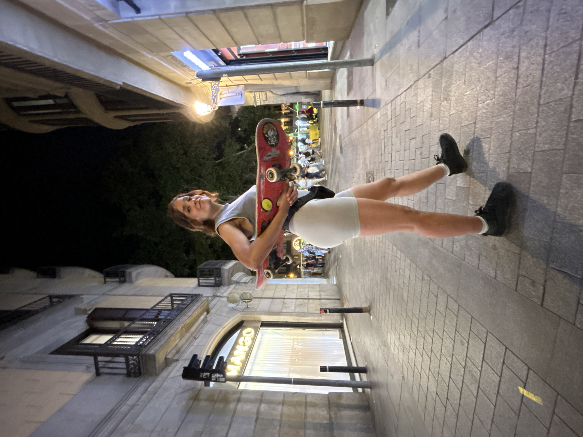 Skateboard and crescent moon, Barcelona streets at night