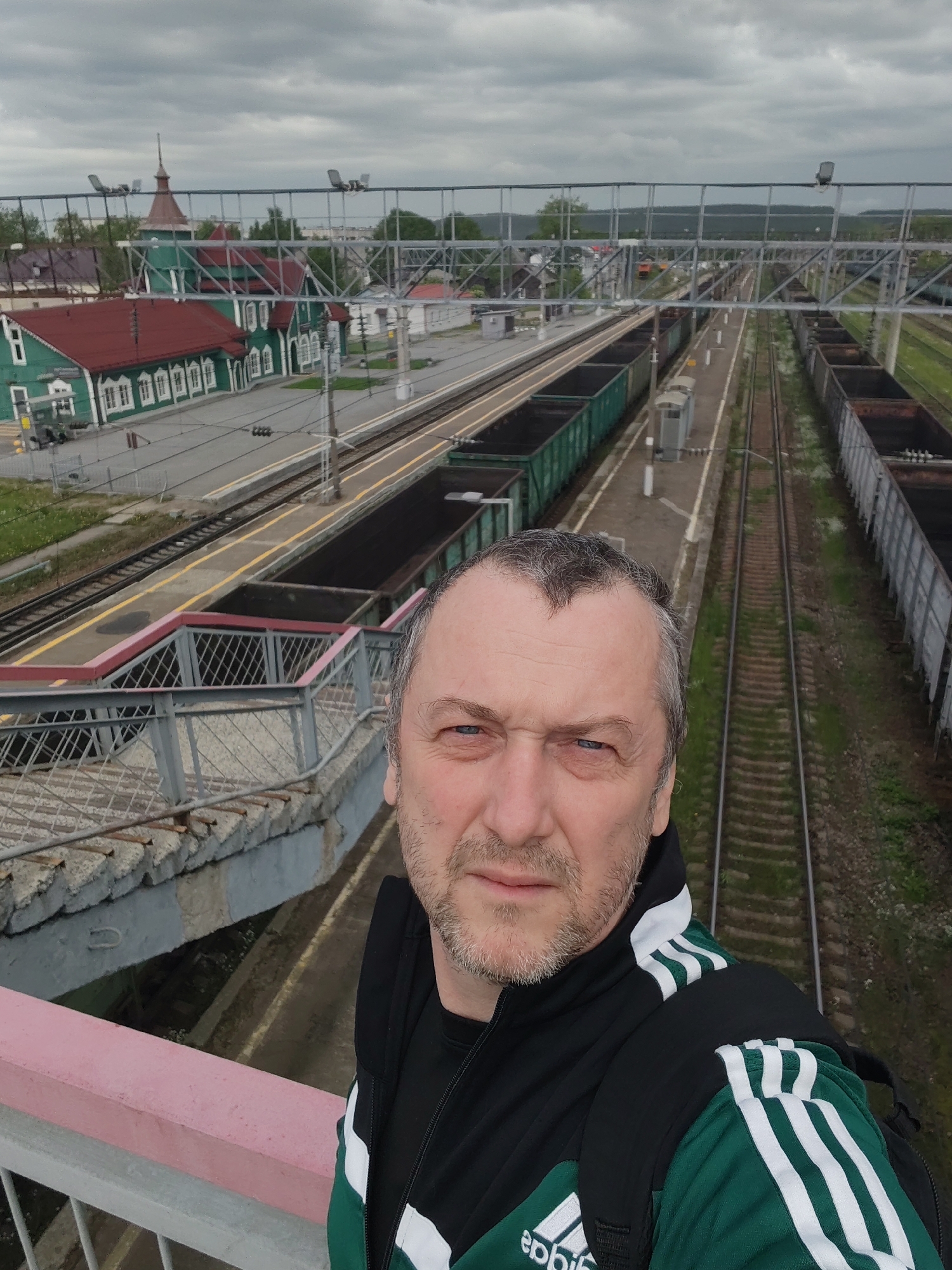Tourist photographs historic railway station in Medvezhyegorsk, Russia