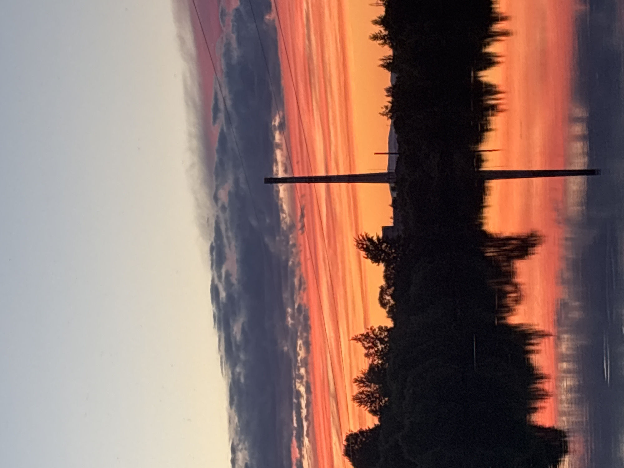 Sunset over Birobidzhan with parked car and power infrastructure
