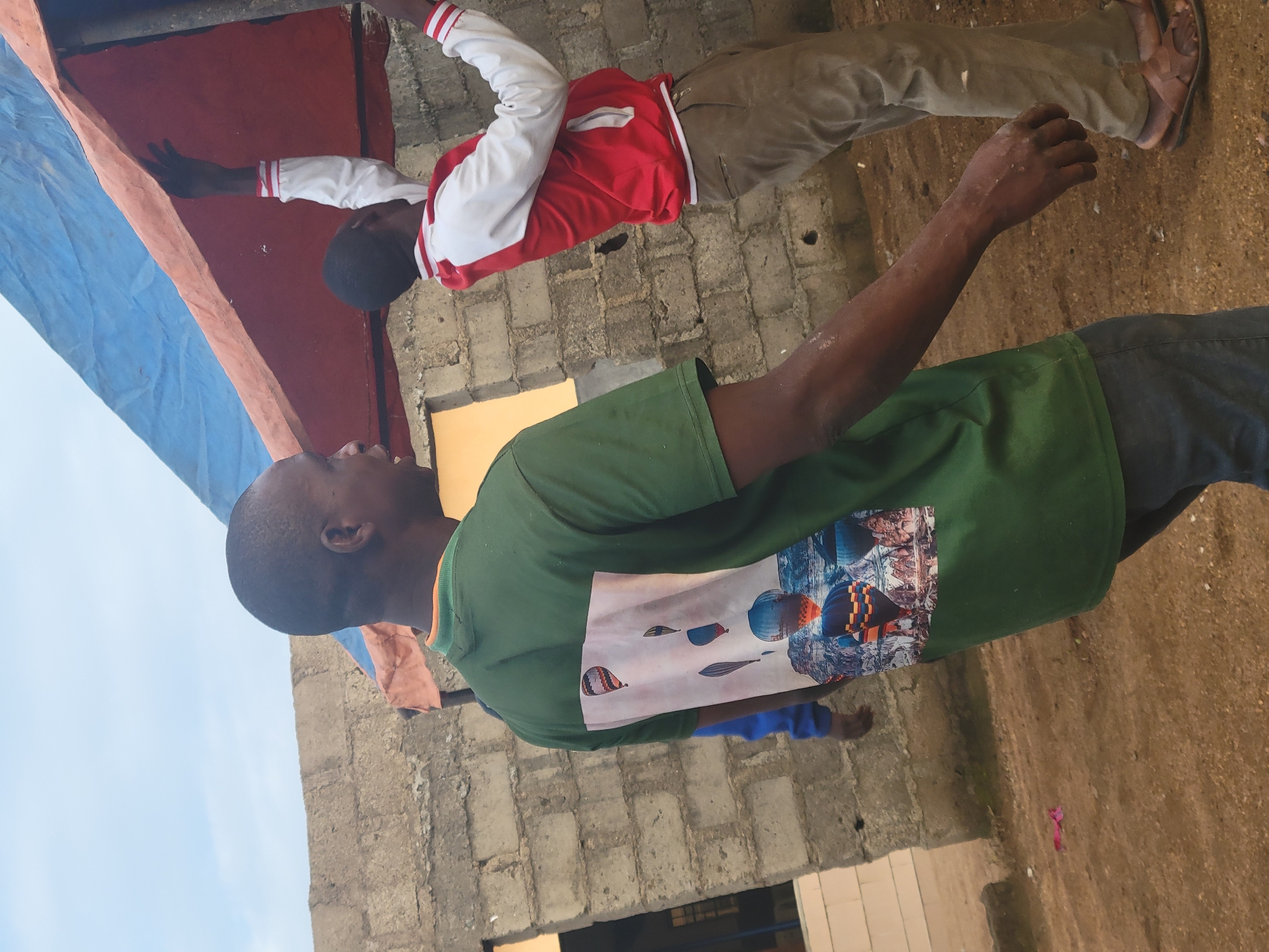 Construction site activity and tarp setup in Madalla, Nigeria