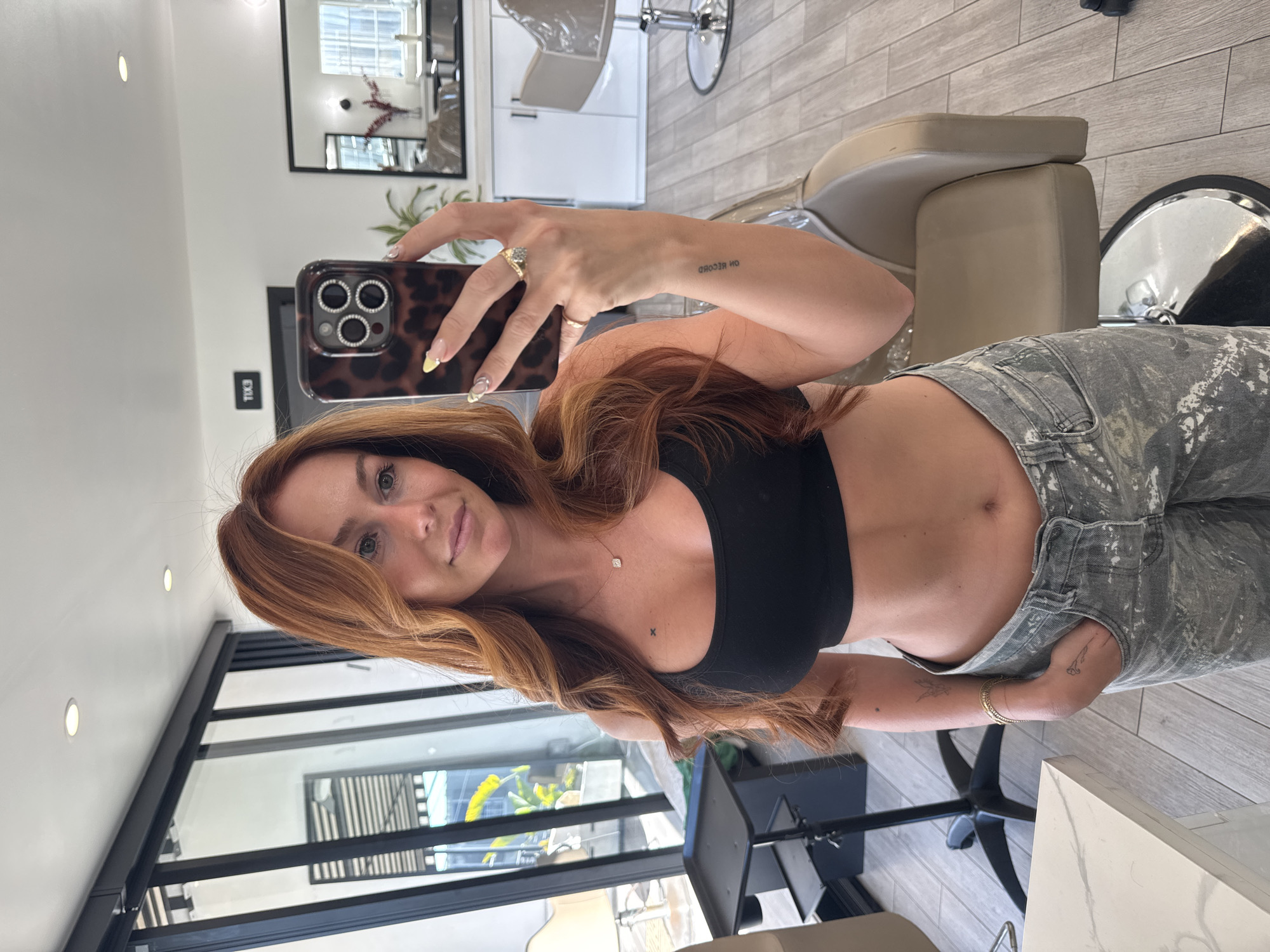 Woman photographed at salon, walking outdoors in late-night Los Angeles