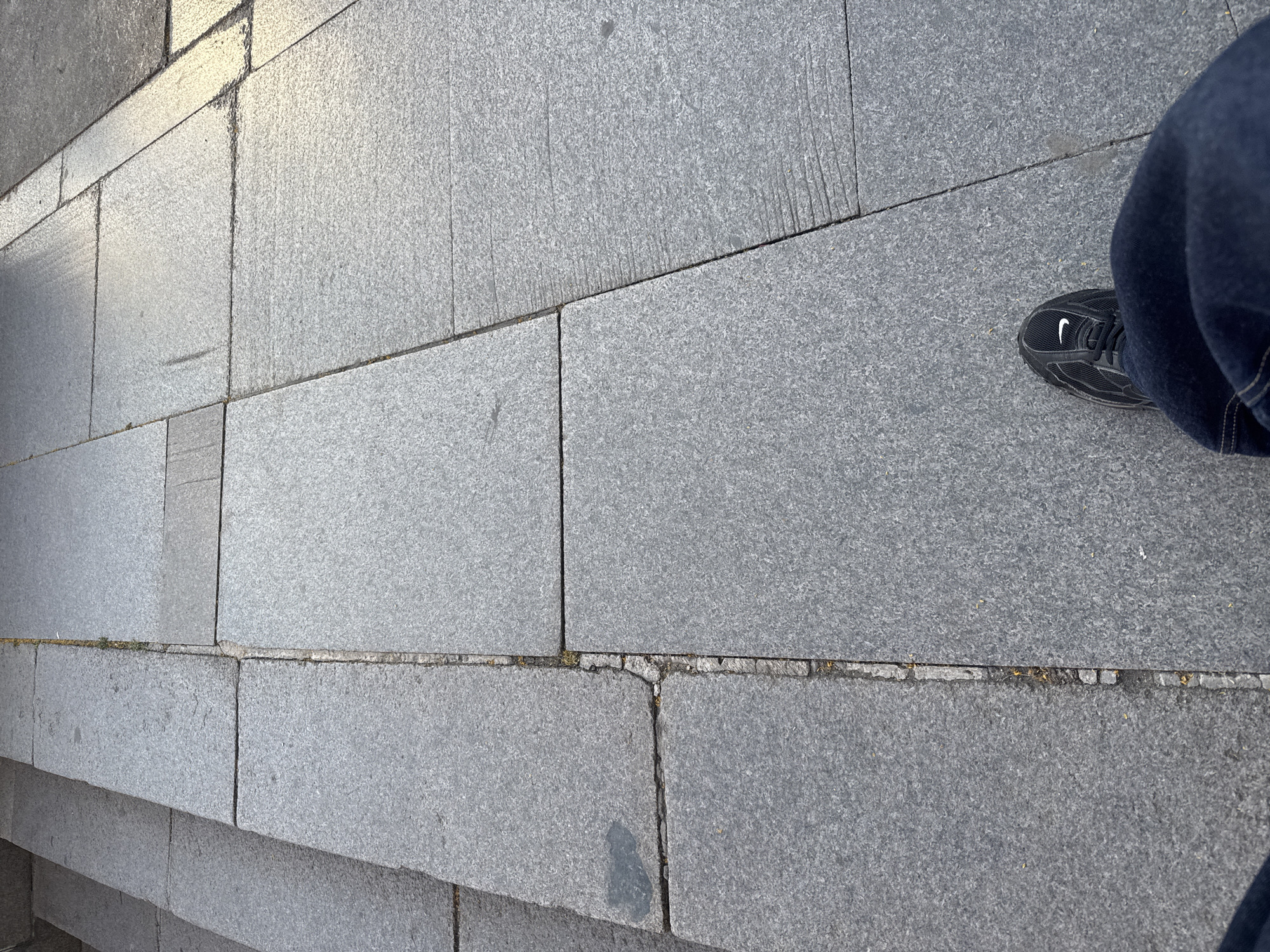 Person documents walk on granite sidewalks in Sofia