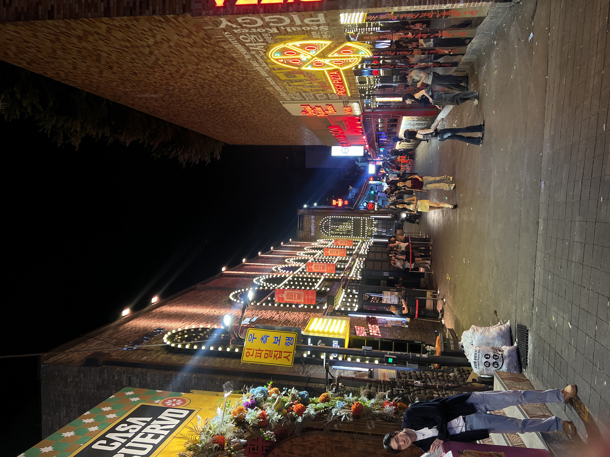 Busy crowds fill neon-lit Itaewon street in Seoul
