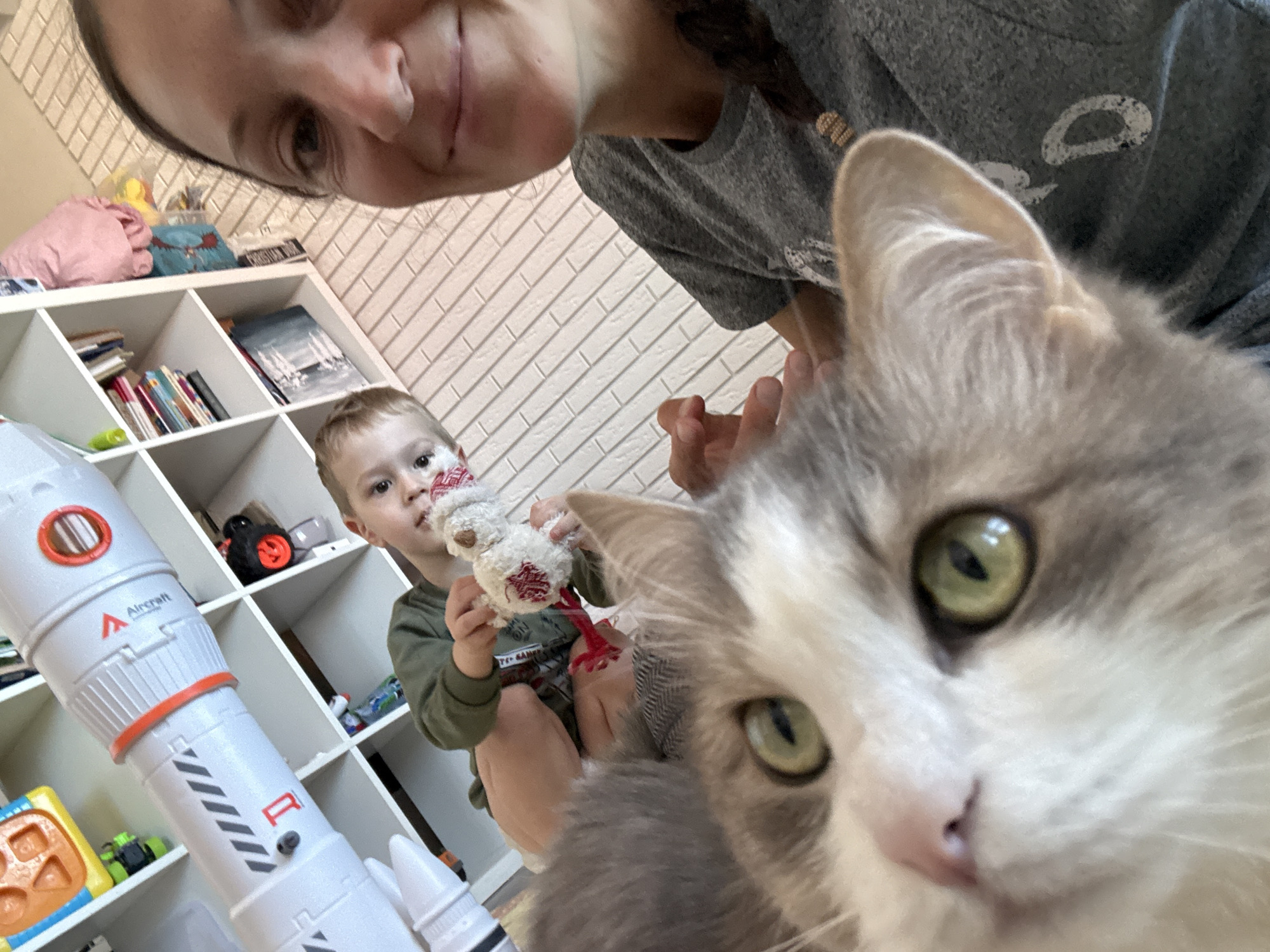 Mother and child play at home with cat in Ulyanovsk
