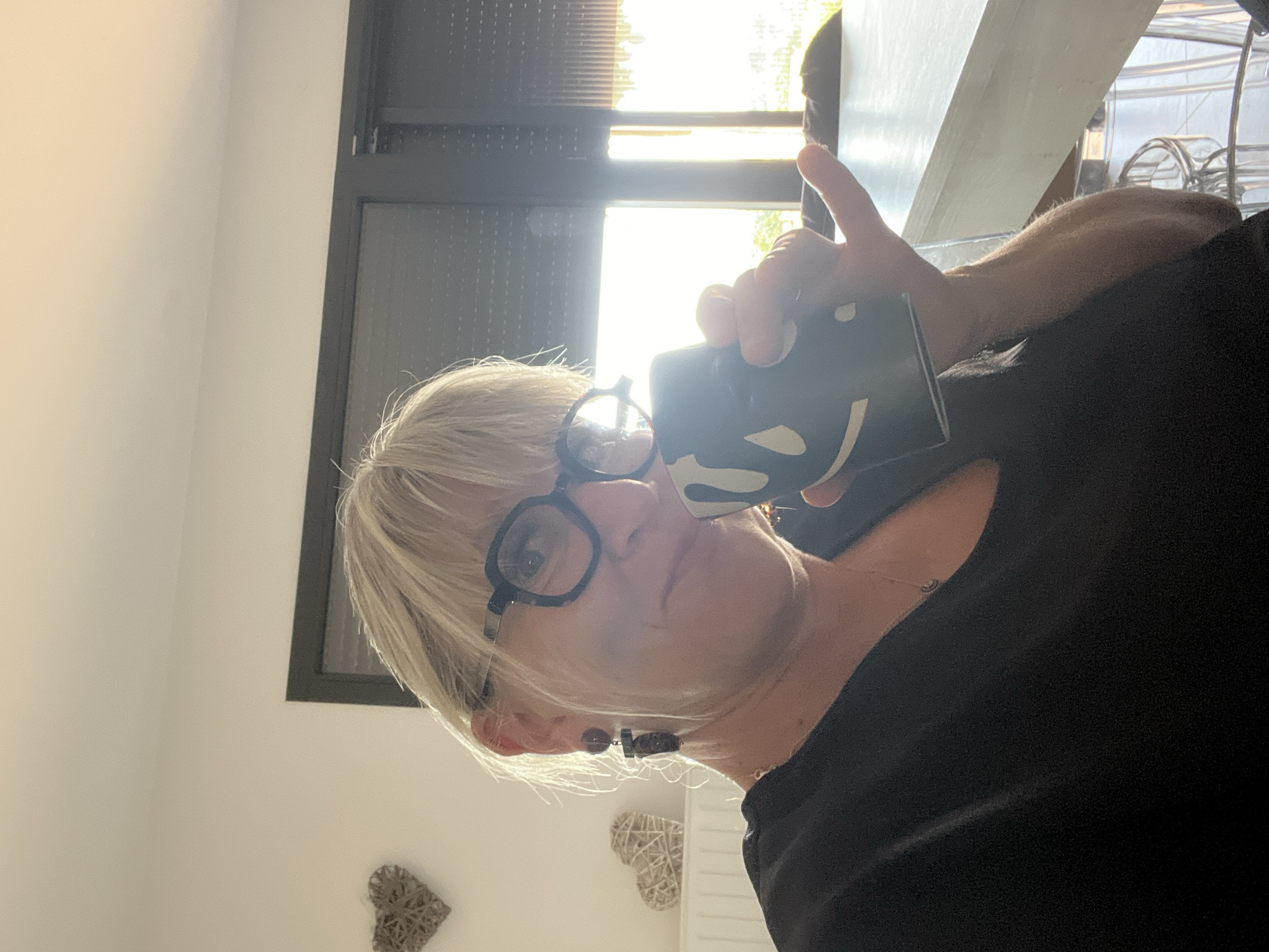 Woman with coffee mug observed in Chambœuf, France