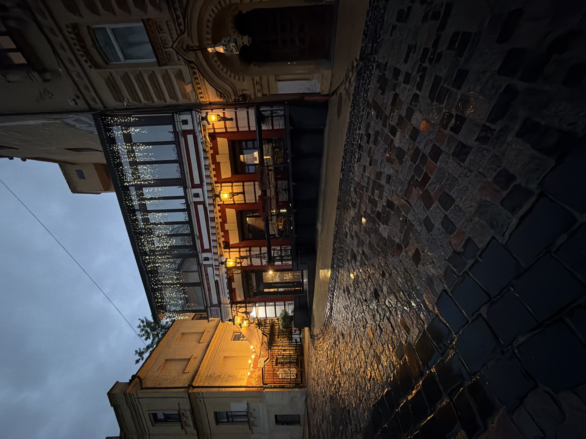 Evening stroll through rainy Kyiv captures church, cafes, wet streets
