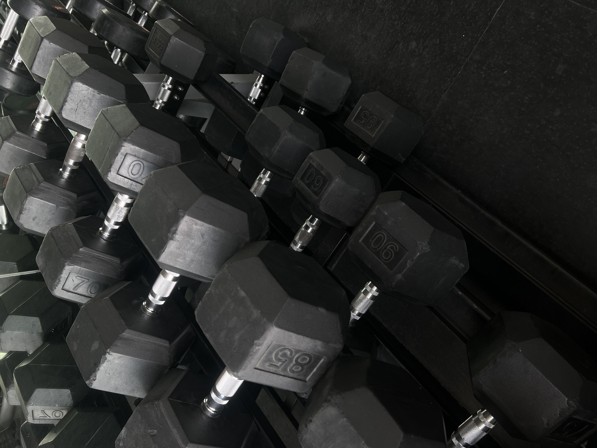 Mexico City gym displays organized heavy dumbbell rack