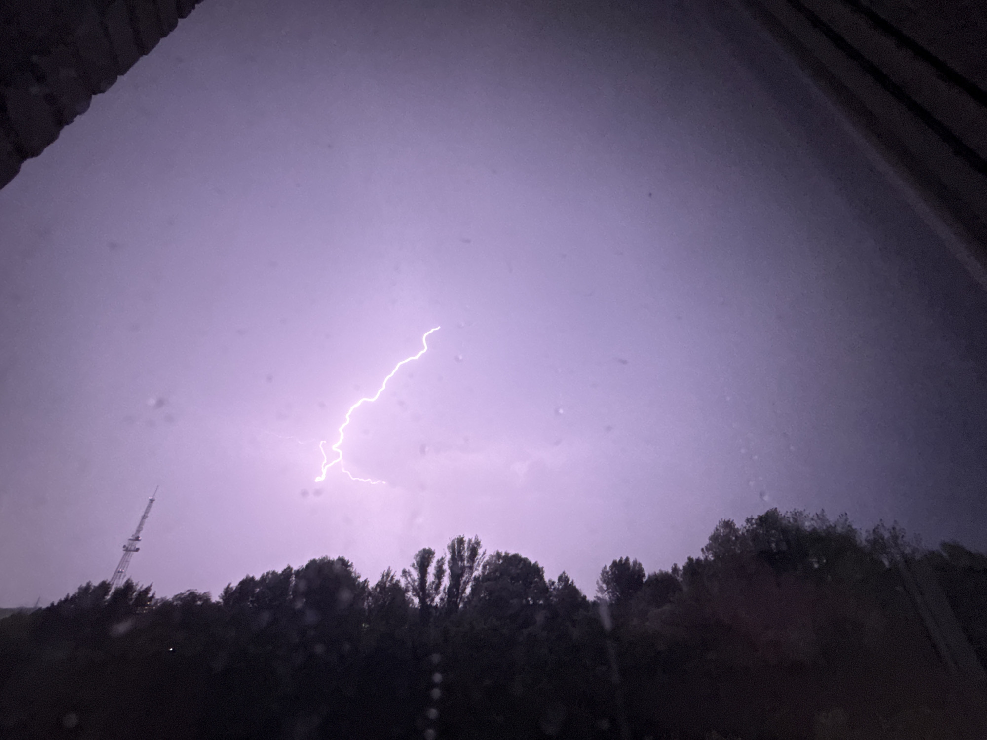 Summer lightning storm over Oskemen with a comms tower nearby