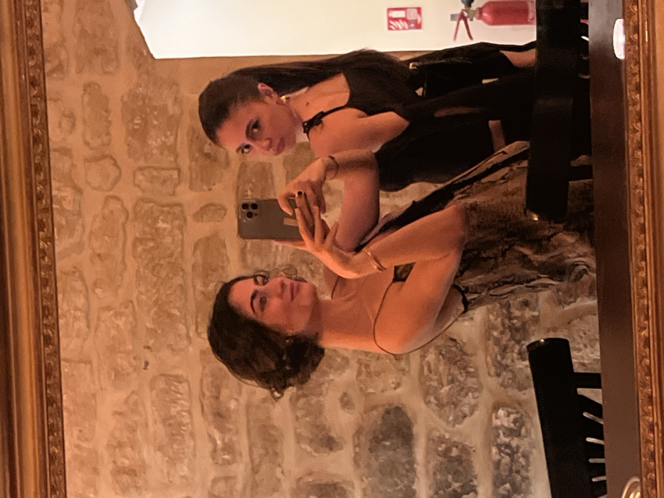 Women document evening dining experience at Paris restaurant