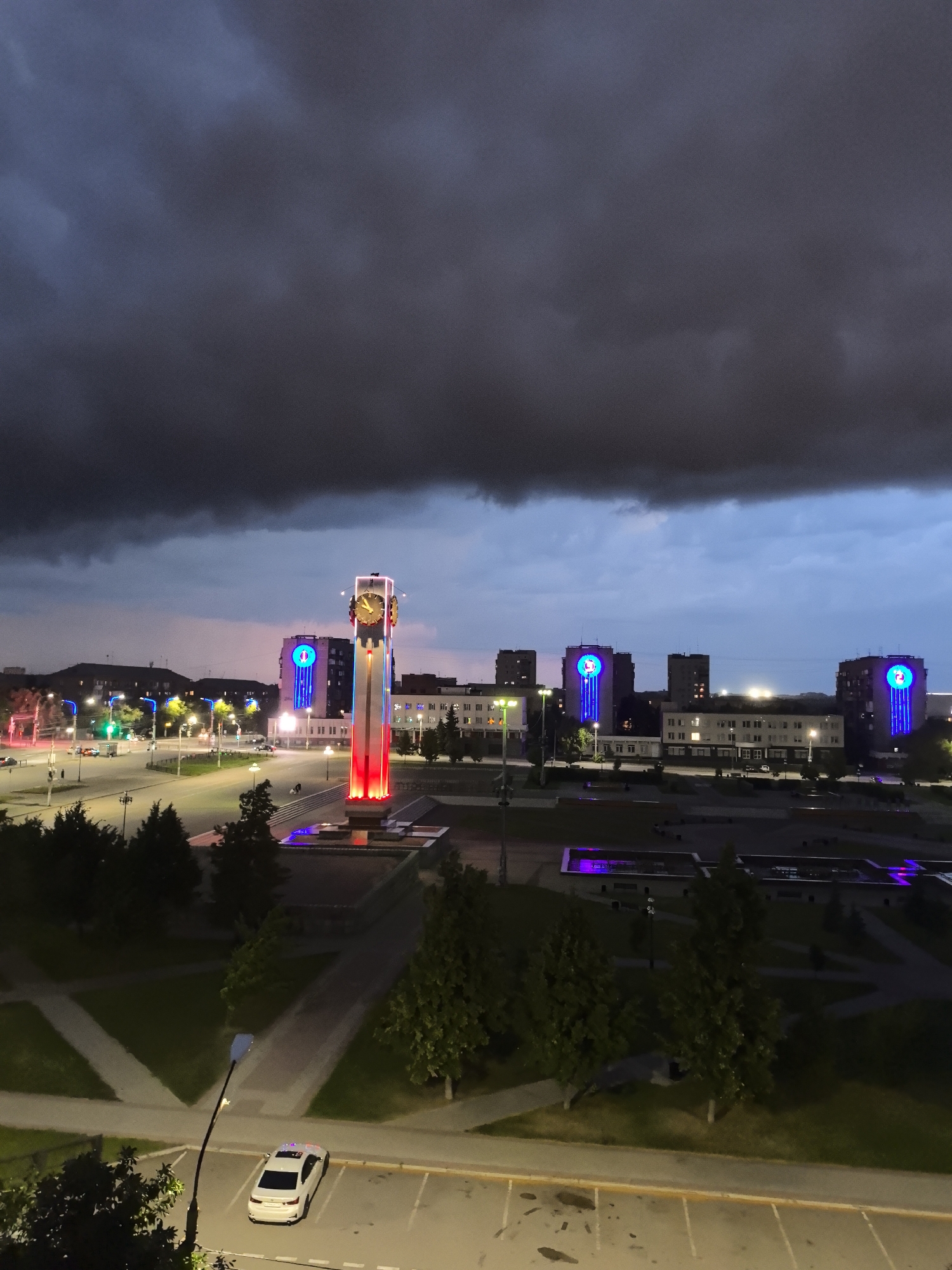 Magnitogorsk city square at night under storm clouds