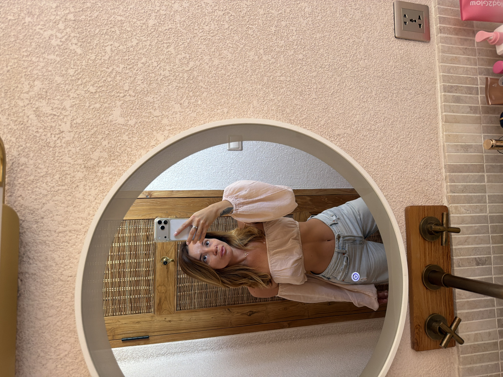 Woman takes bathroom mirror selfies in Mengwi, Indonesia