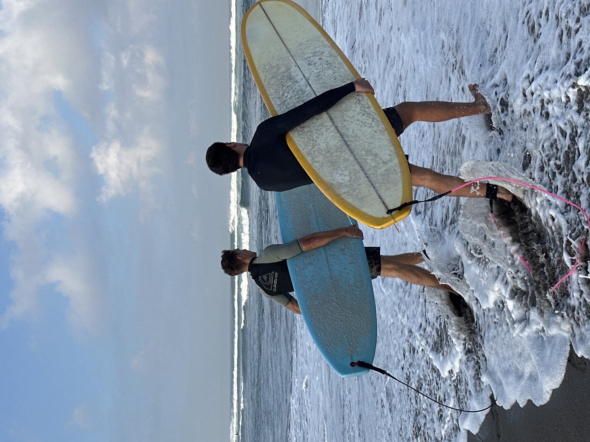 Surfers and beachgoers on a North Kuta morning