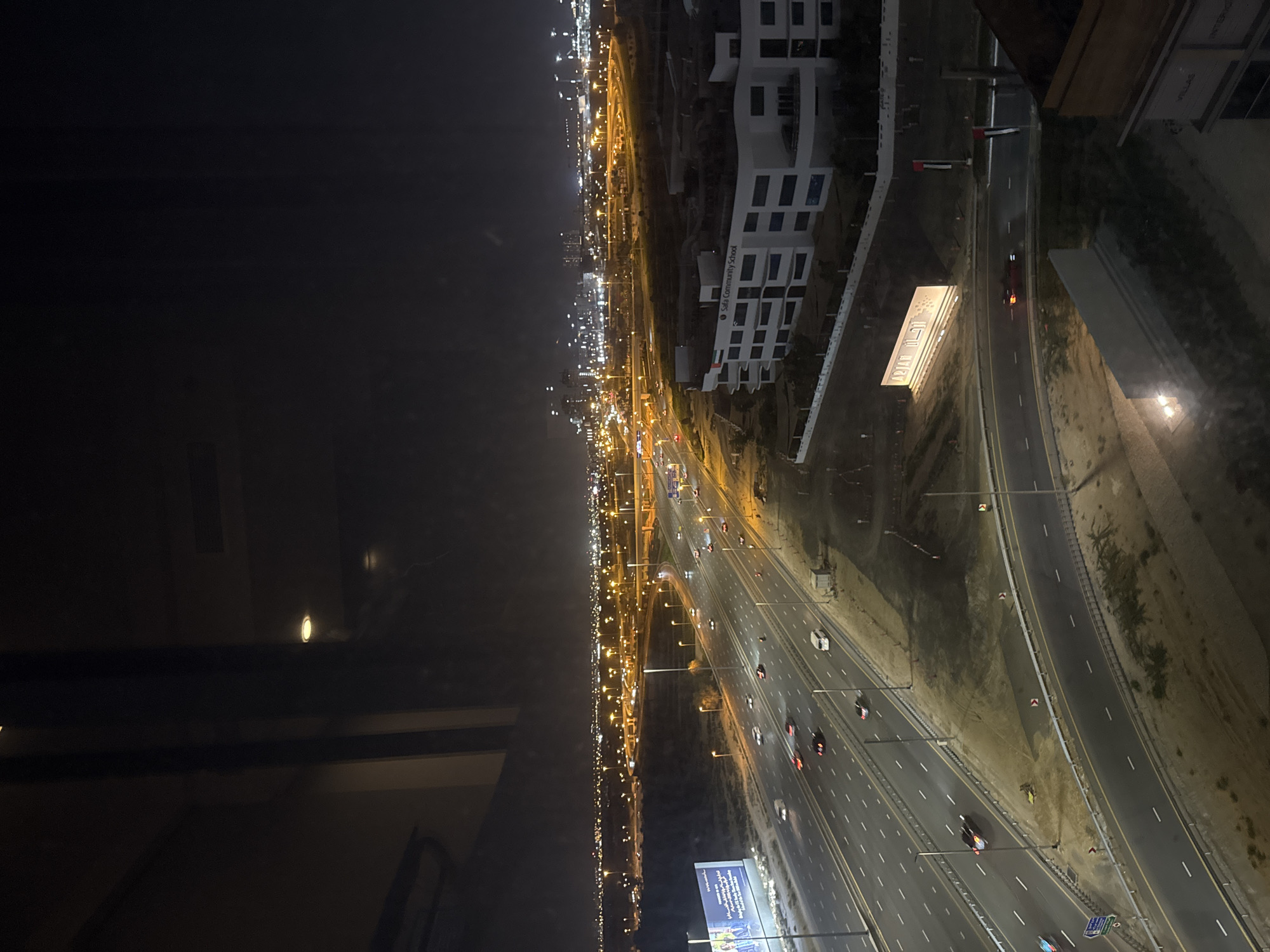 Evening traffic flows on illuminated Dubai highway