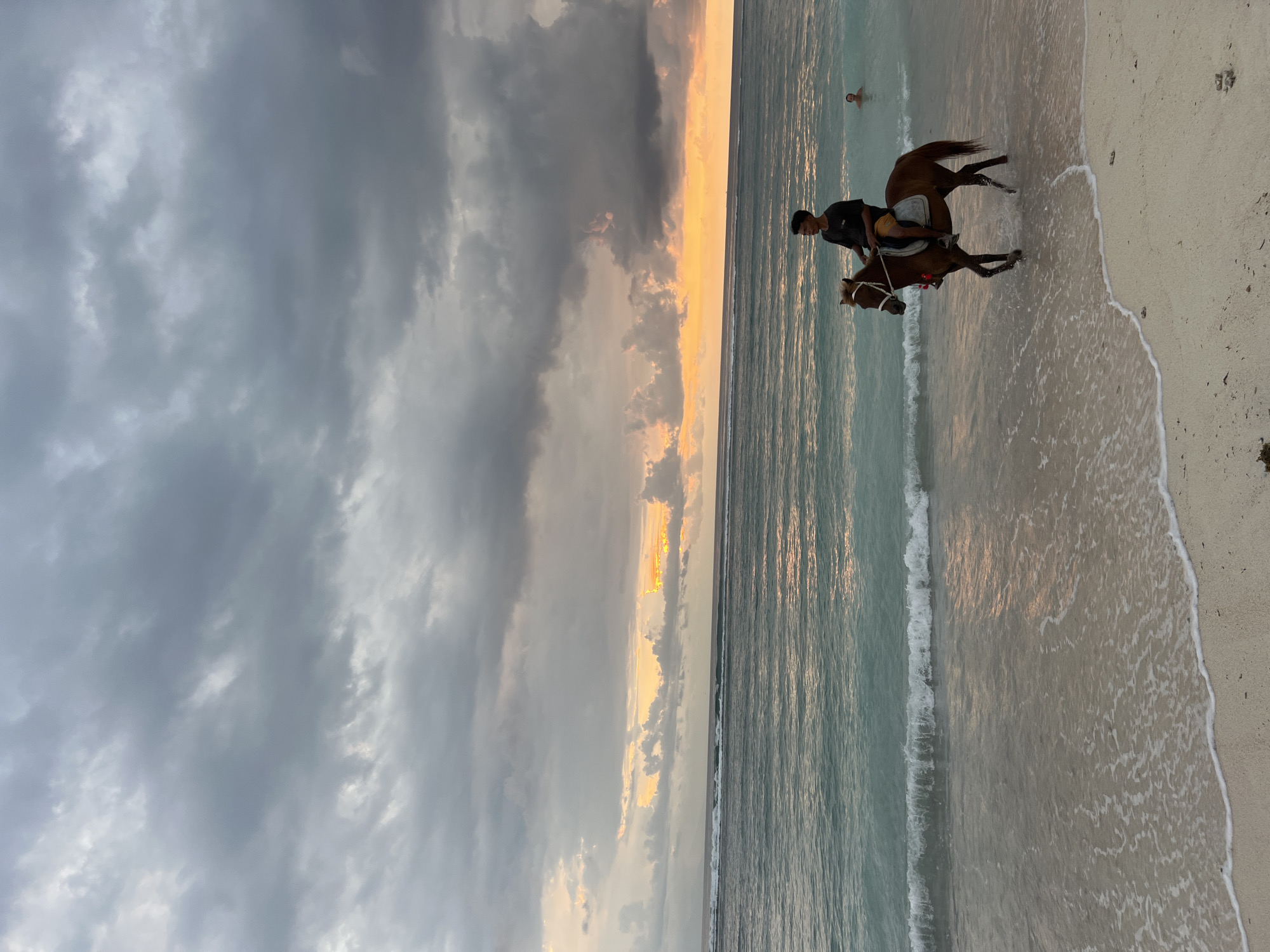 Horse rider spotted on Indonesian beach under cloudy skies