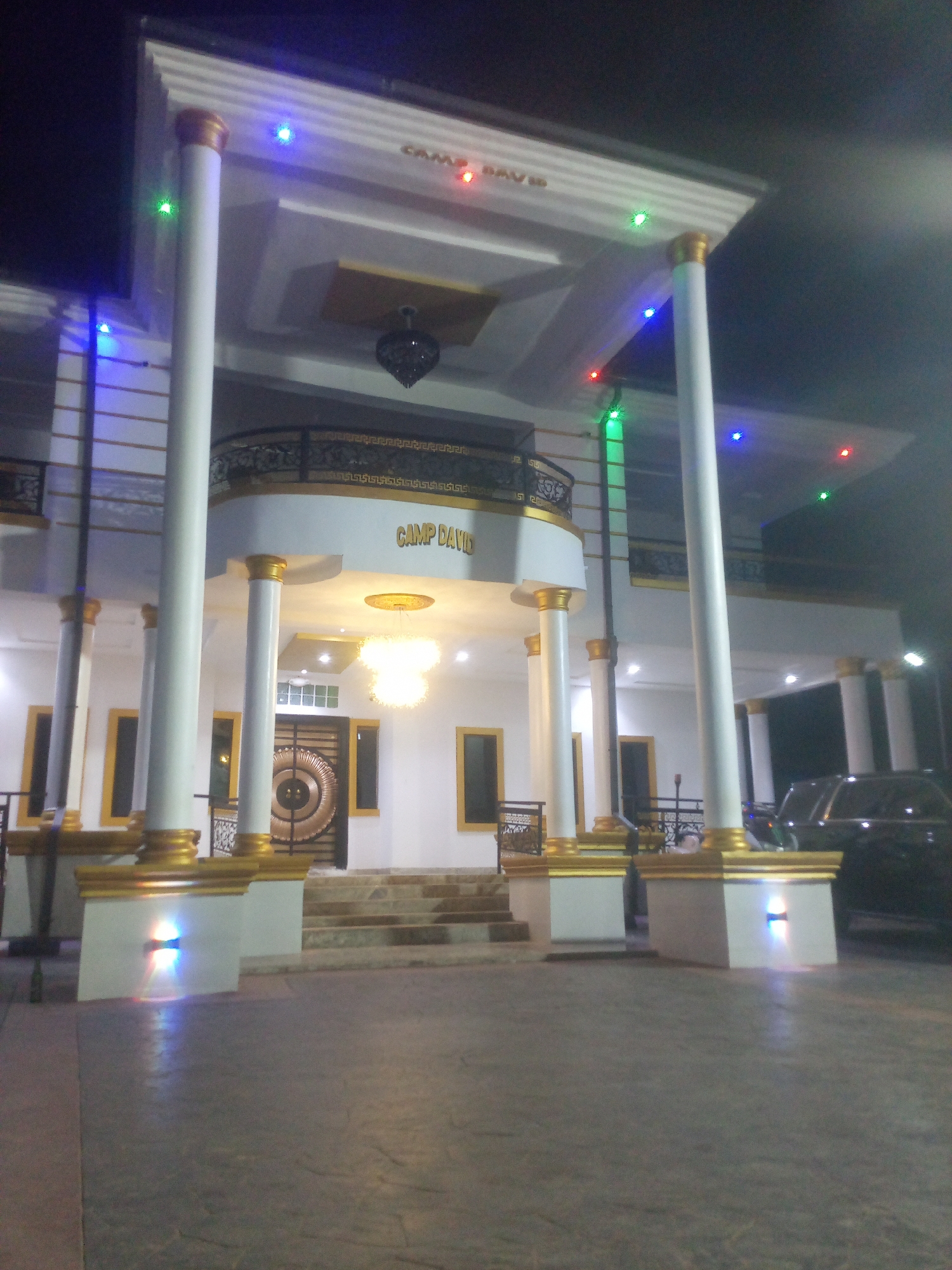 Evening gathering at grand columned building in Bende, Nigeria