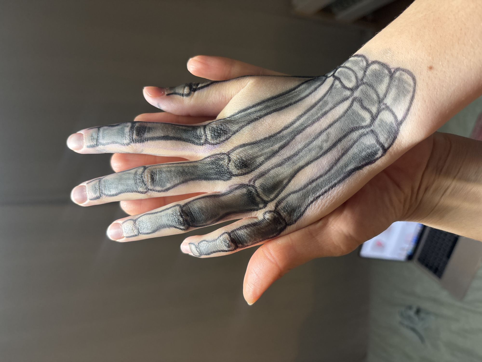 Woman displays skeleton hand art in Chaikovsky, Russia