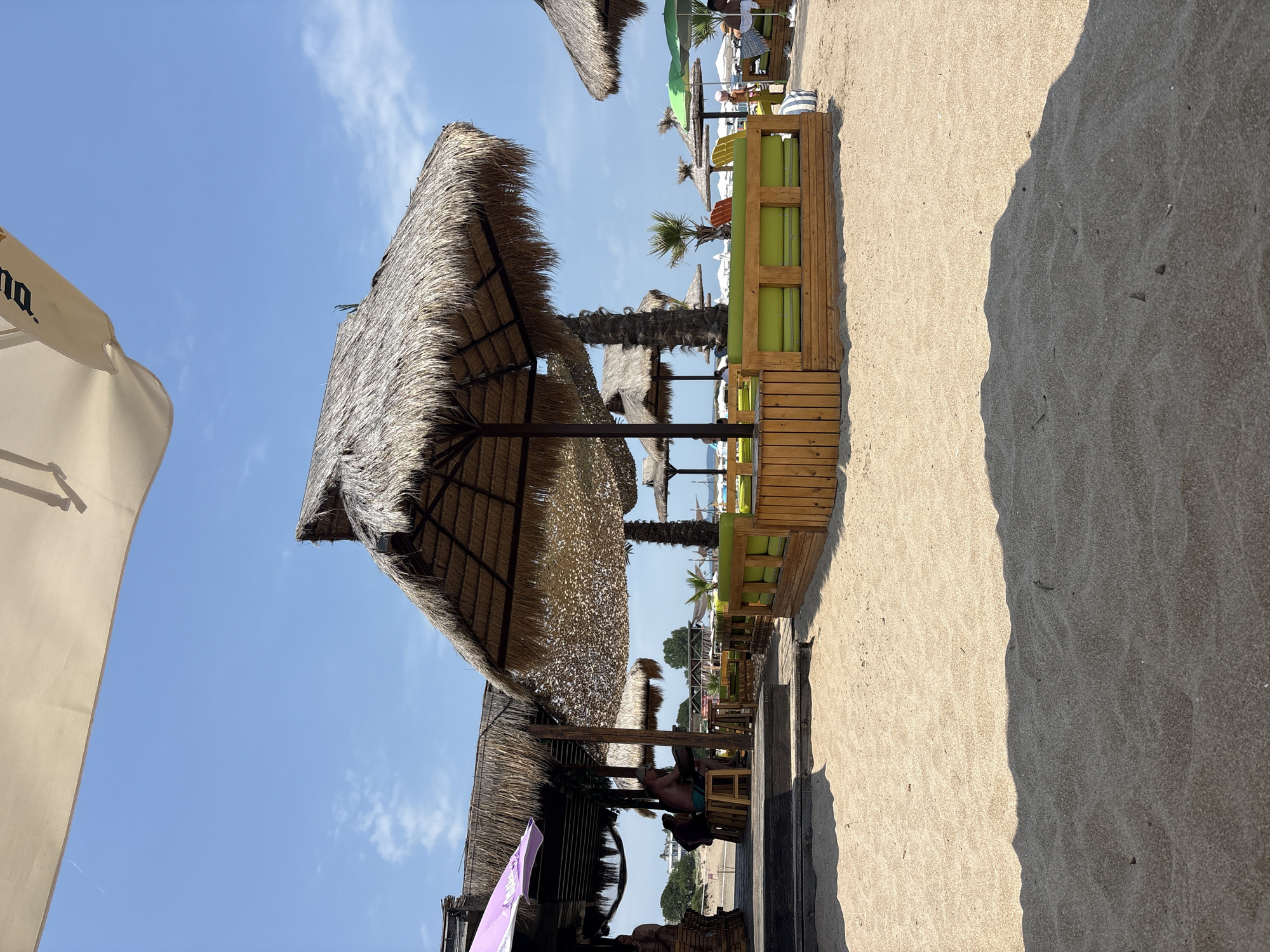 Sunny beach with a striking shadow across the sand