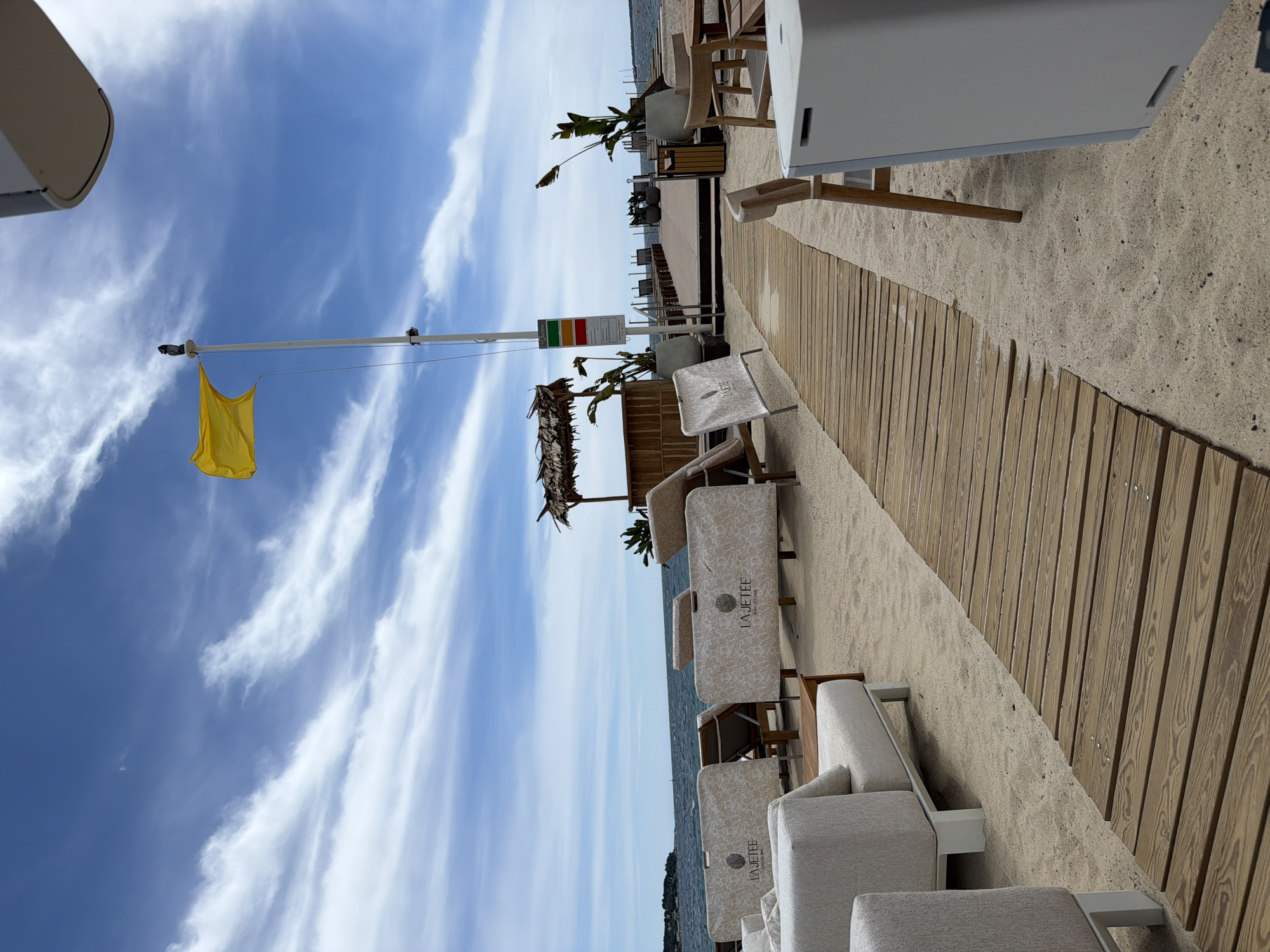 Yellow flag flies at La Jettee beach boardwalk
