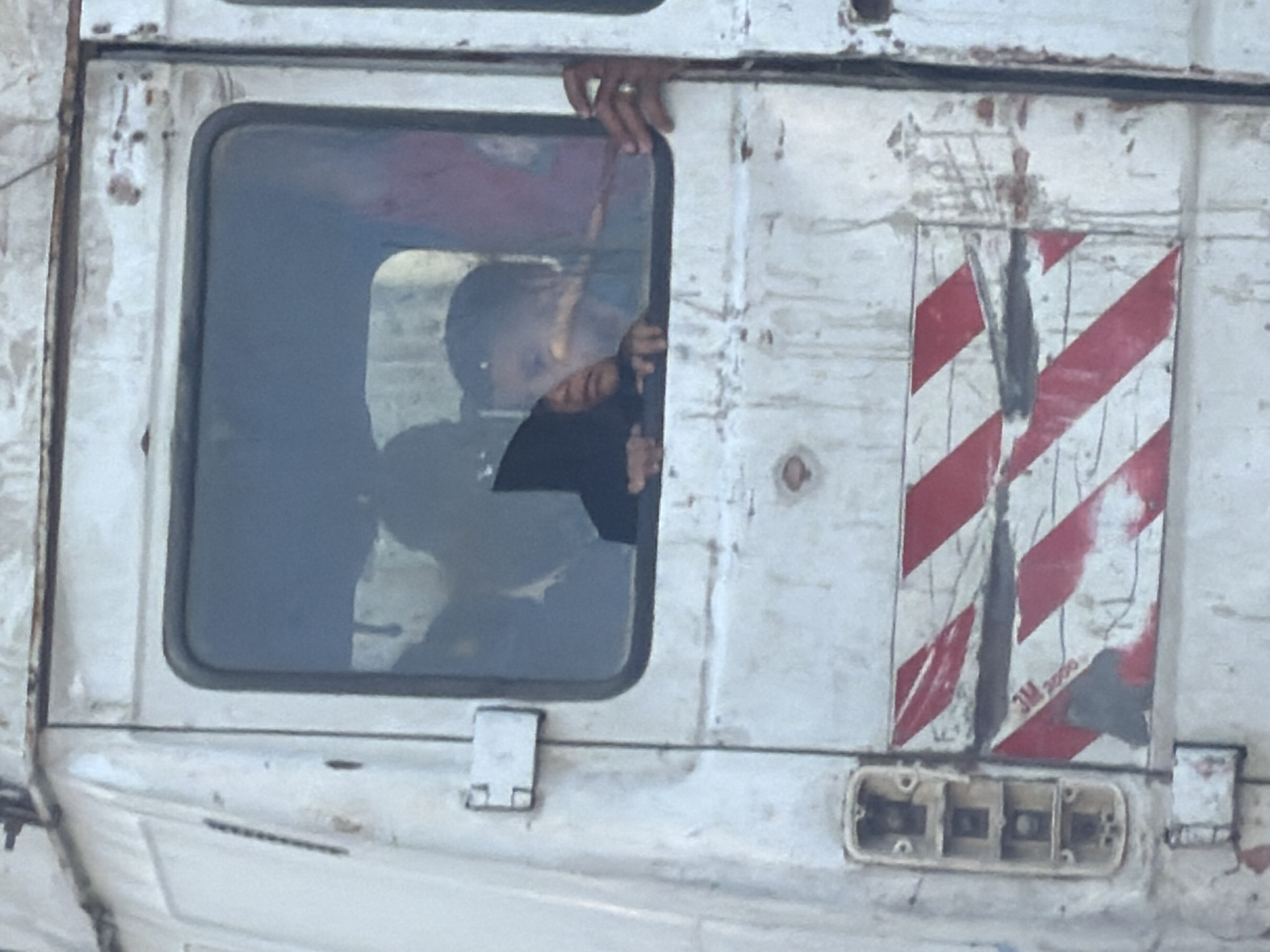 Person seen in window of worn truck in Gaza