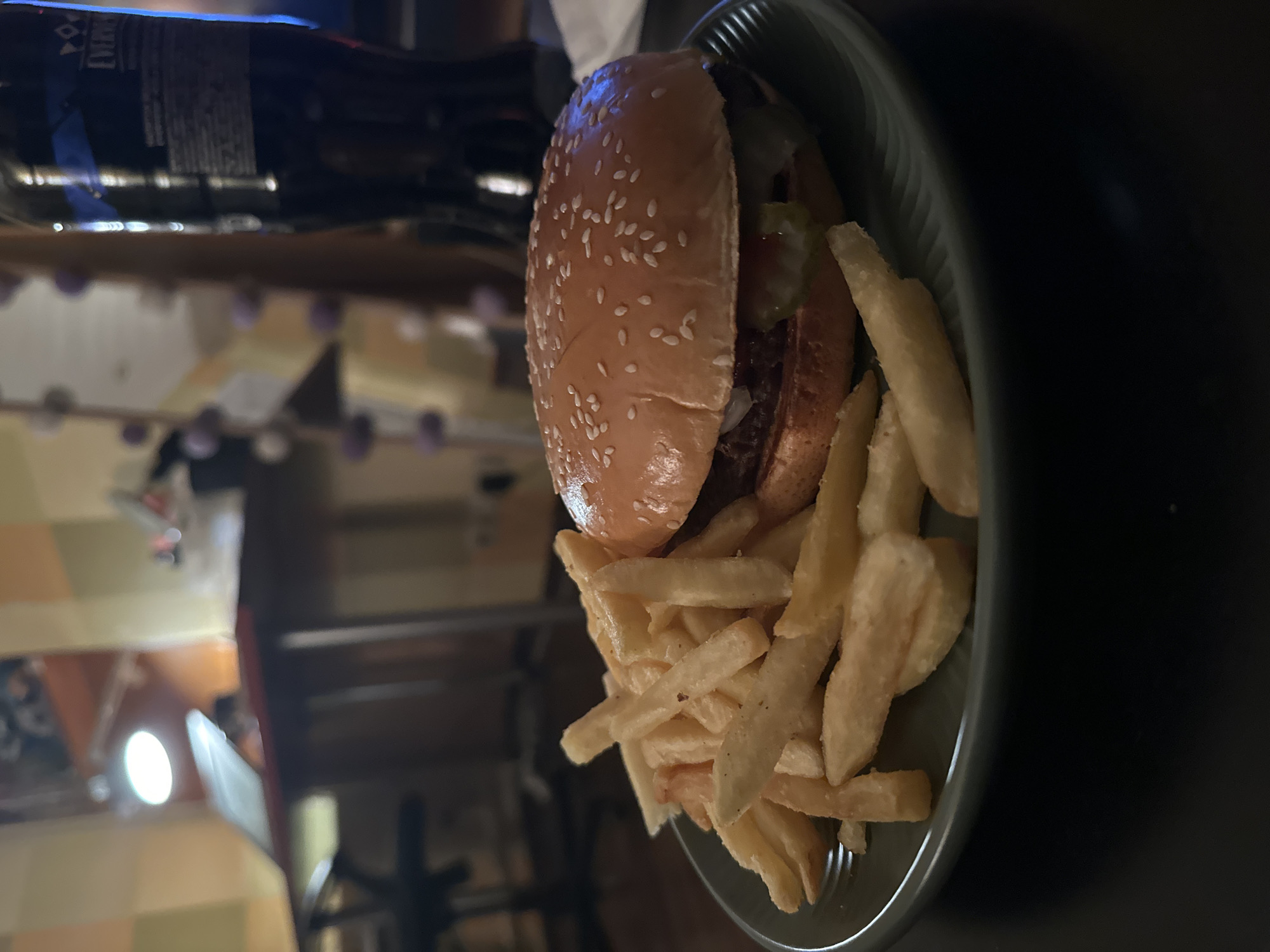 Person enjoys burger and fries while watching TV in Moscow