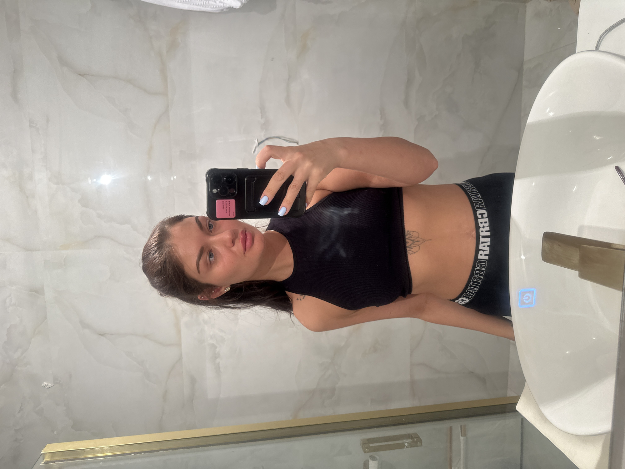 Woman takes mirror selfie in Moscow bathroom