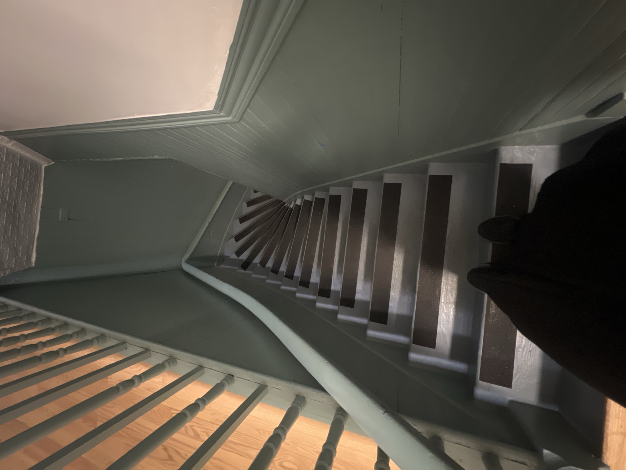 Interior staircase with green walls photographed in New York