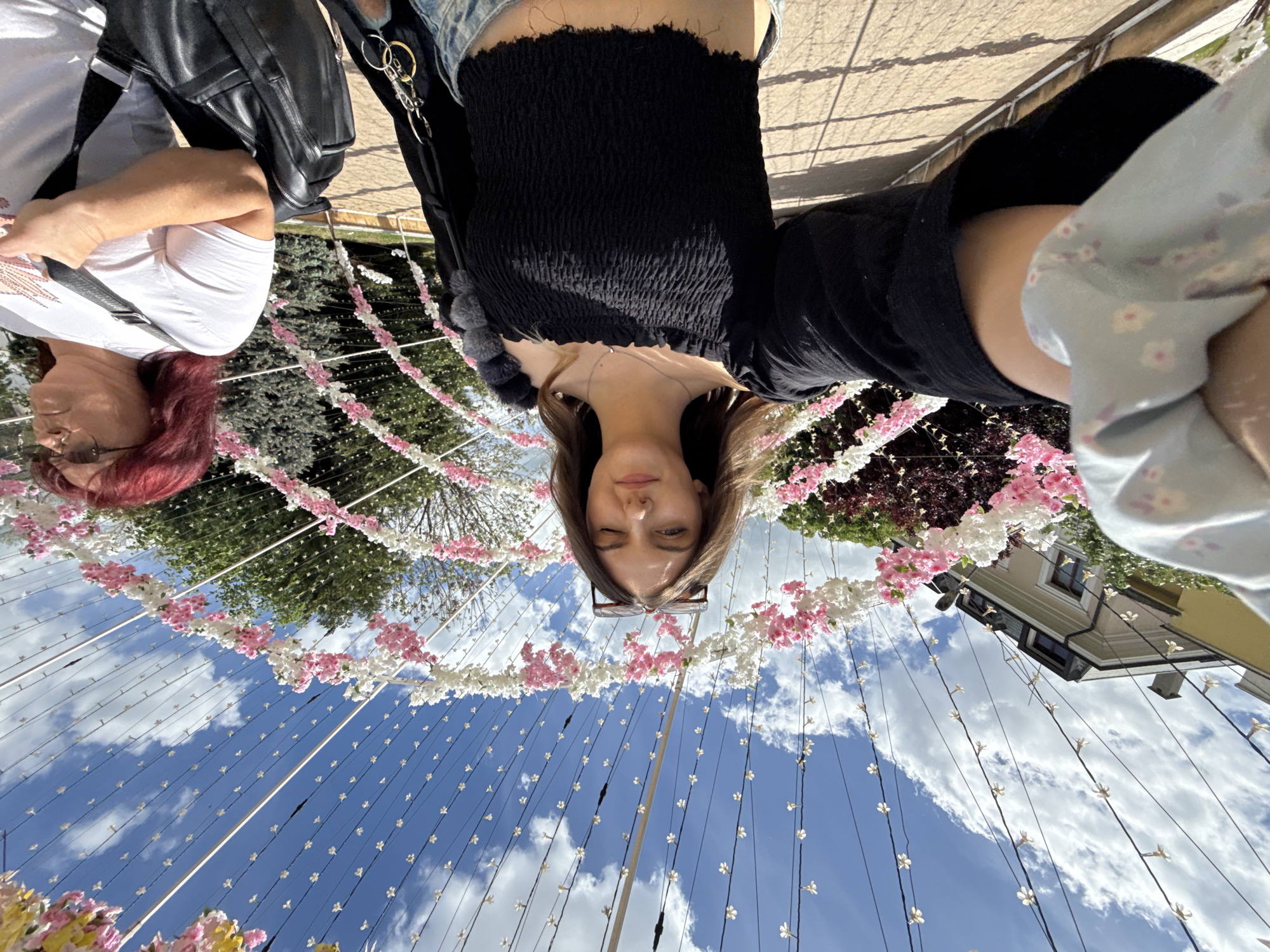 Woman poses near floral tunnel display in Sliven
