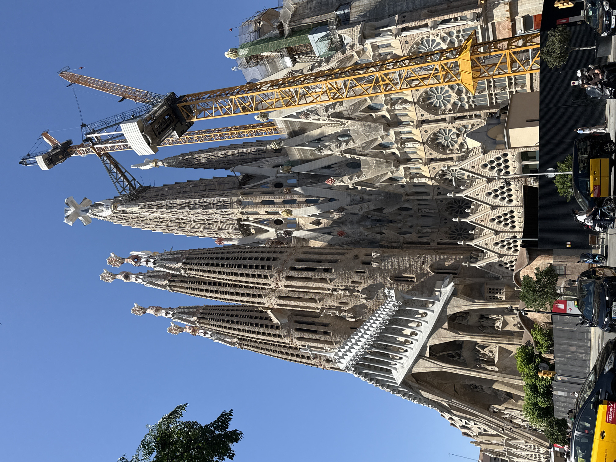 Sagrada Família on a sunny Barcelona afternoon, cranes and all