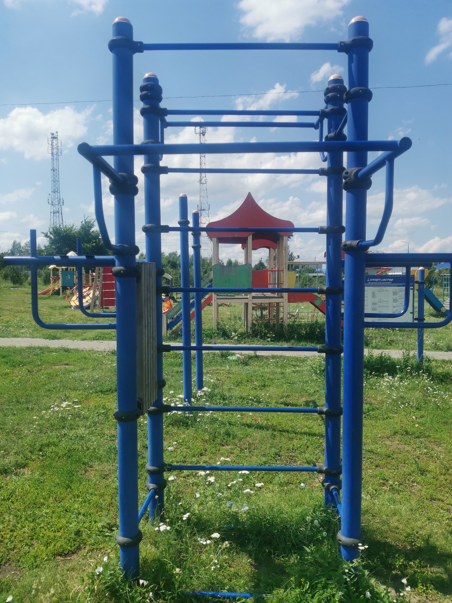 Community park with playgrounds, outdoor gym, and sports fields