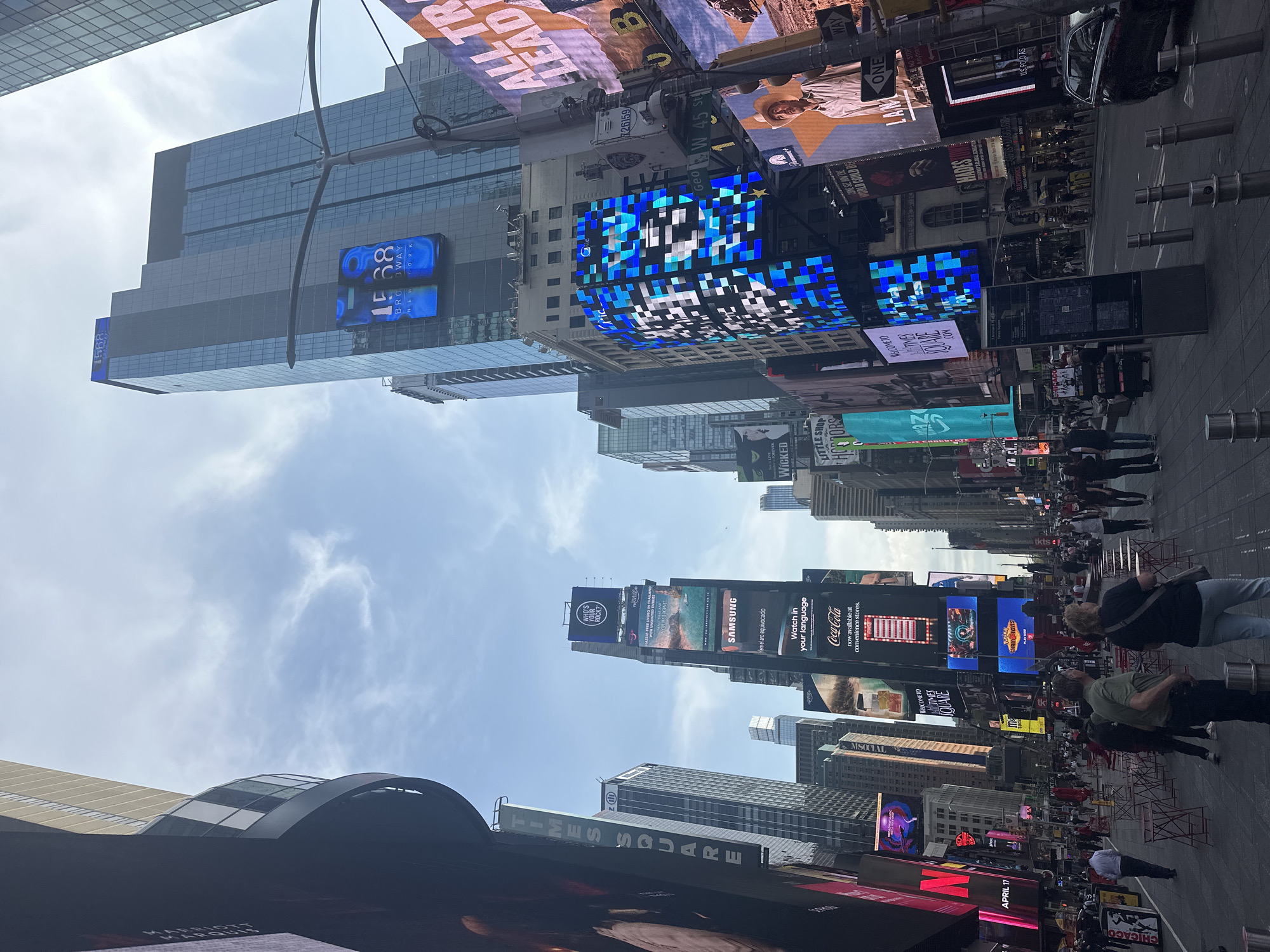 Times Square digital billboards documented in afternoon street scenes