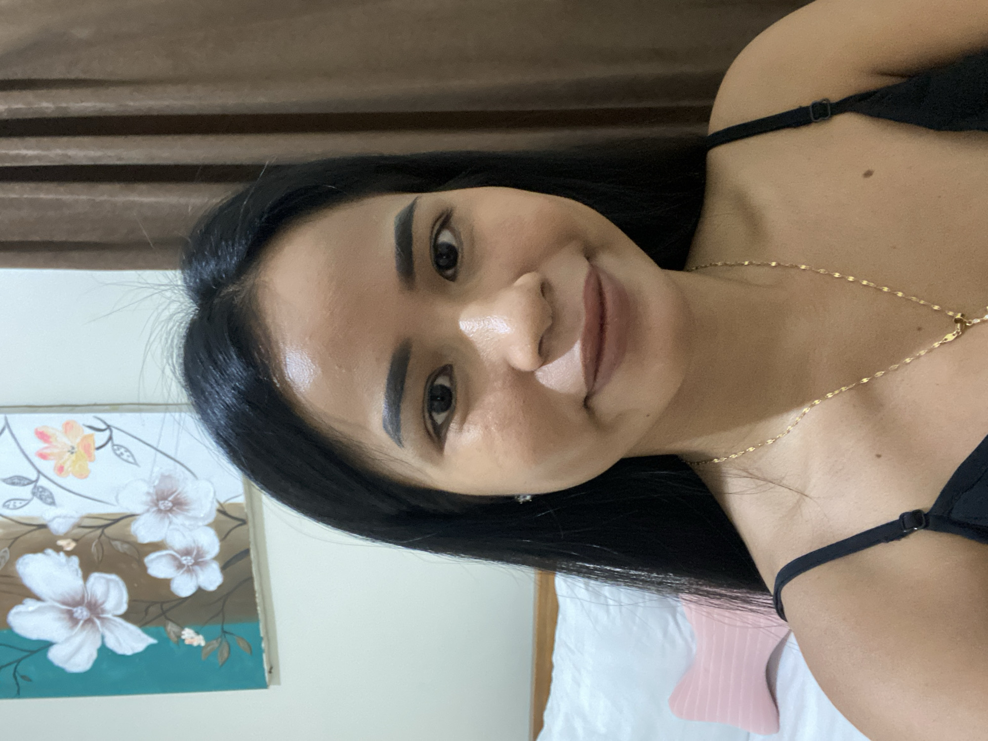 Woman photographed smiling indoors in North Kuta, Indonesia