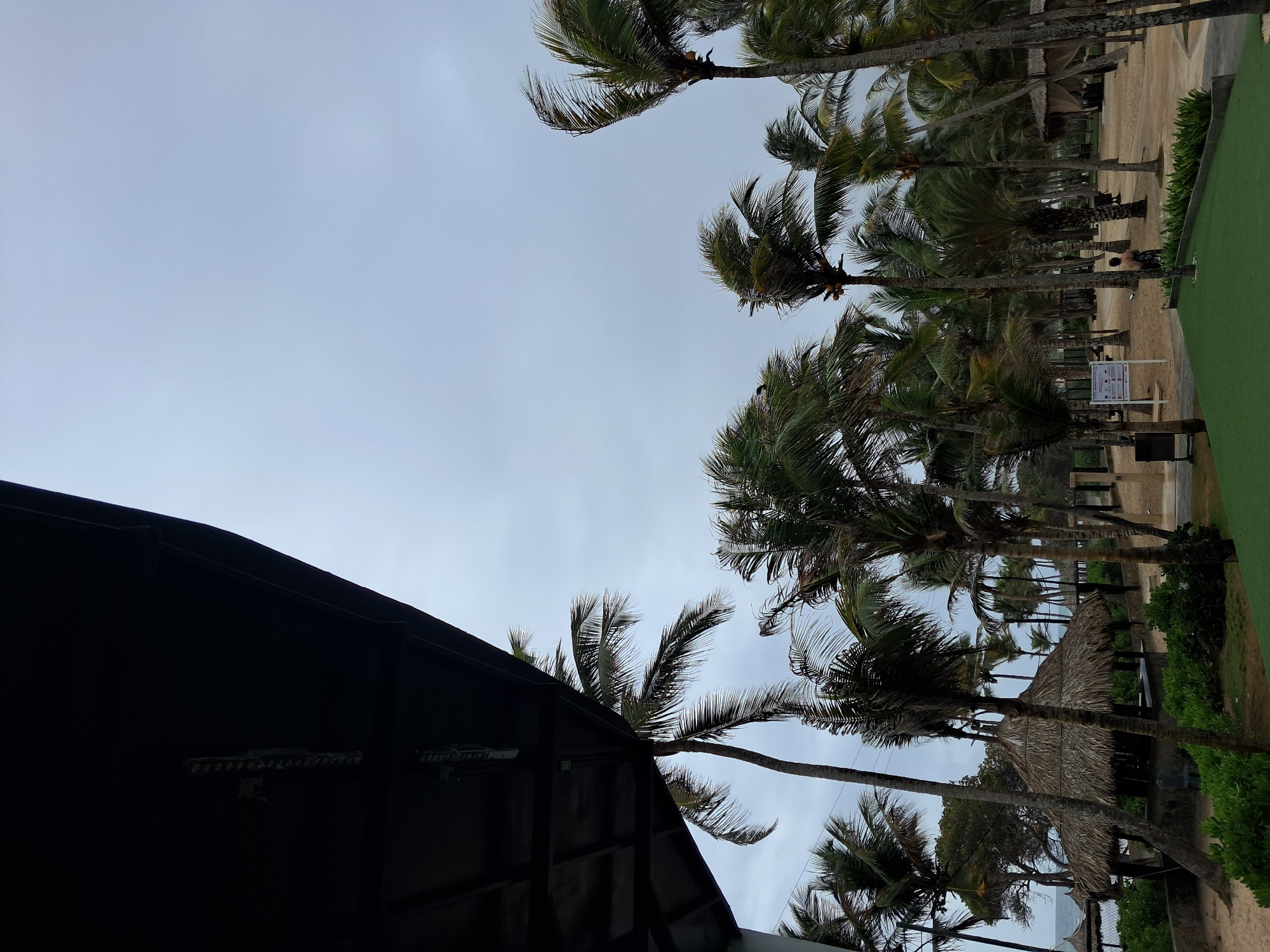 Tourist documents Venezuelan resort during overcast afternoon