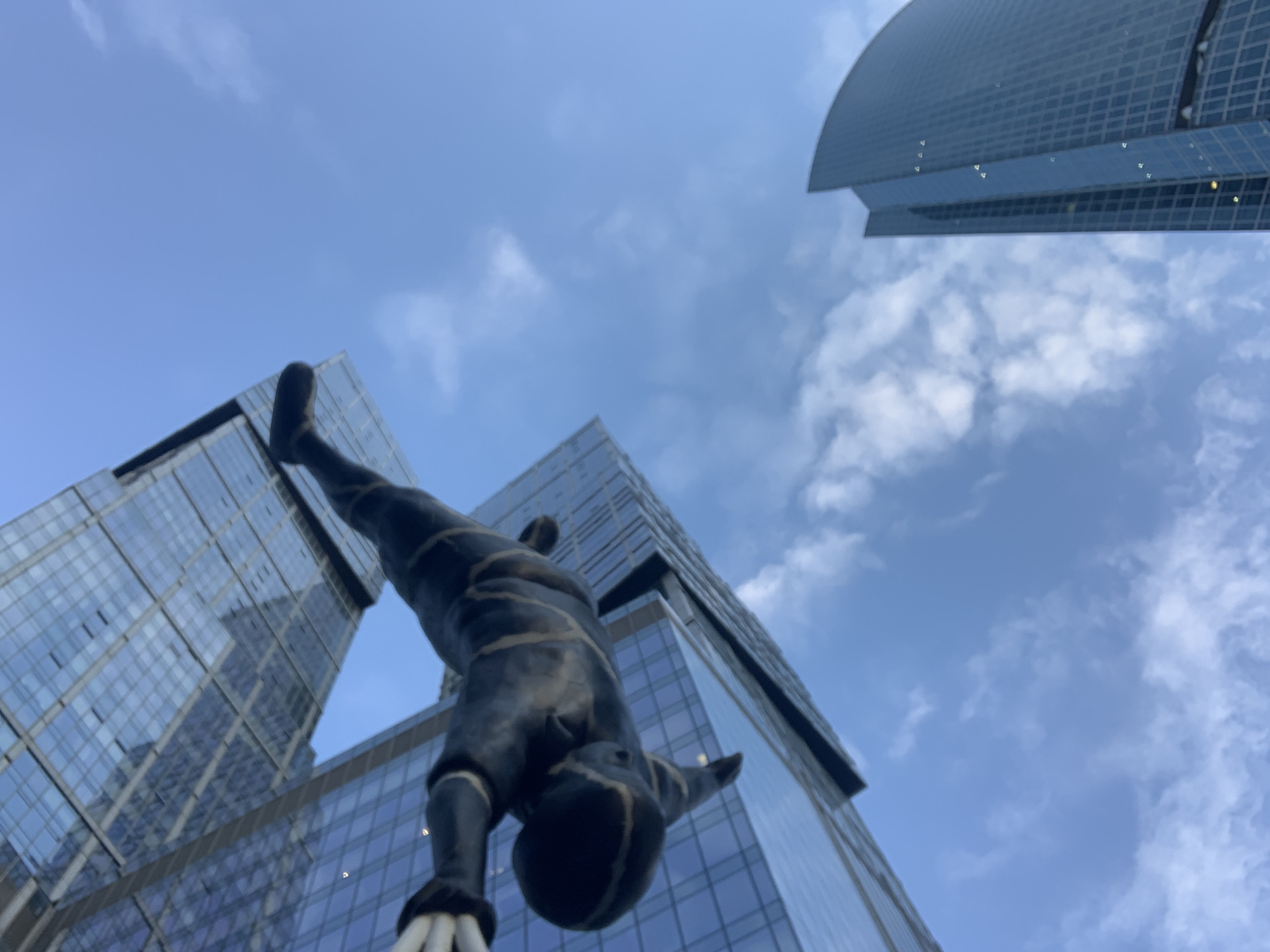 Handstand statue photographed against skyscrapers in Khimki, Russia