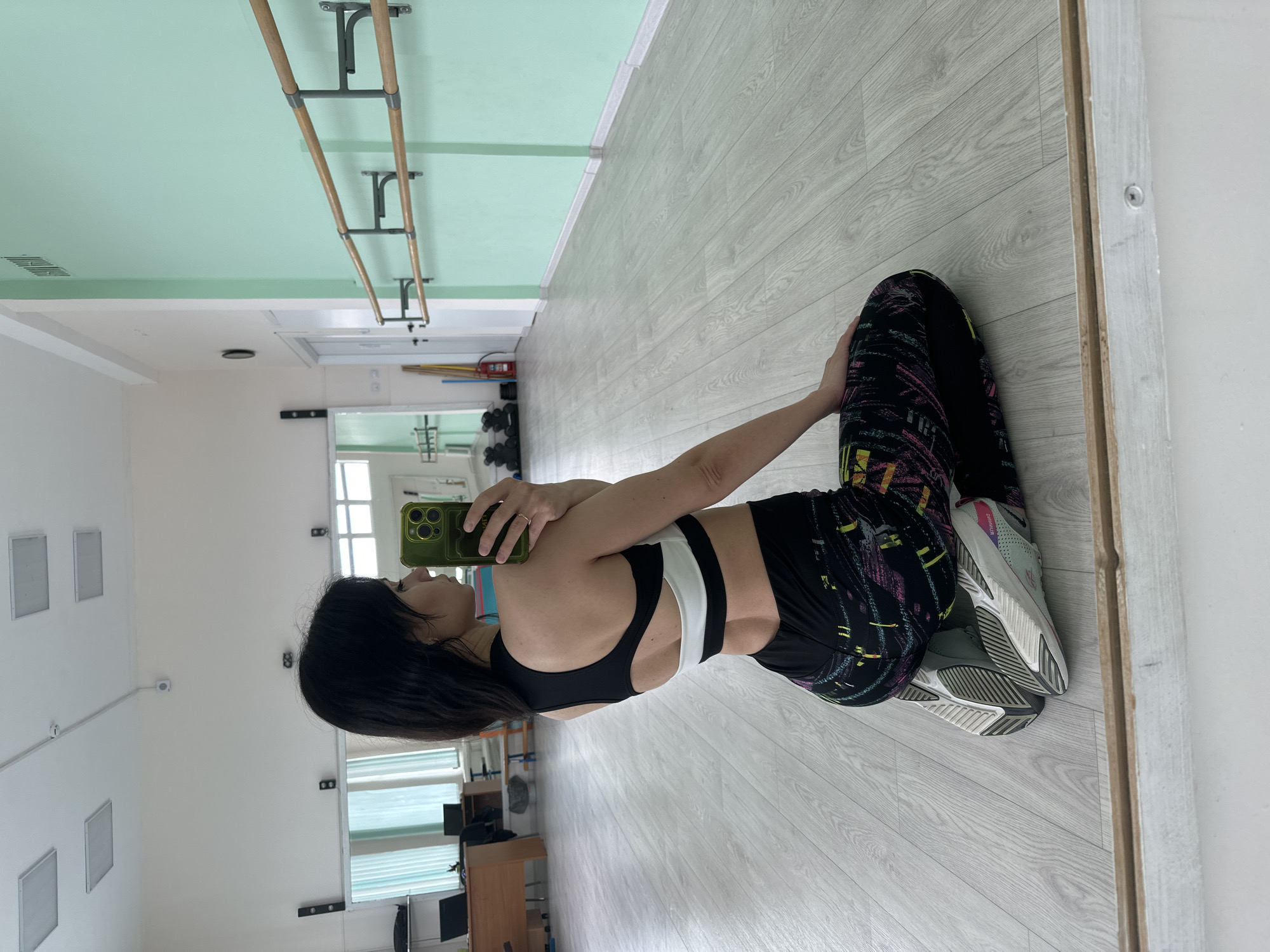 Woman takes selfies in dance studio during morning session