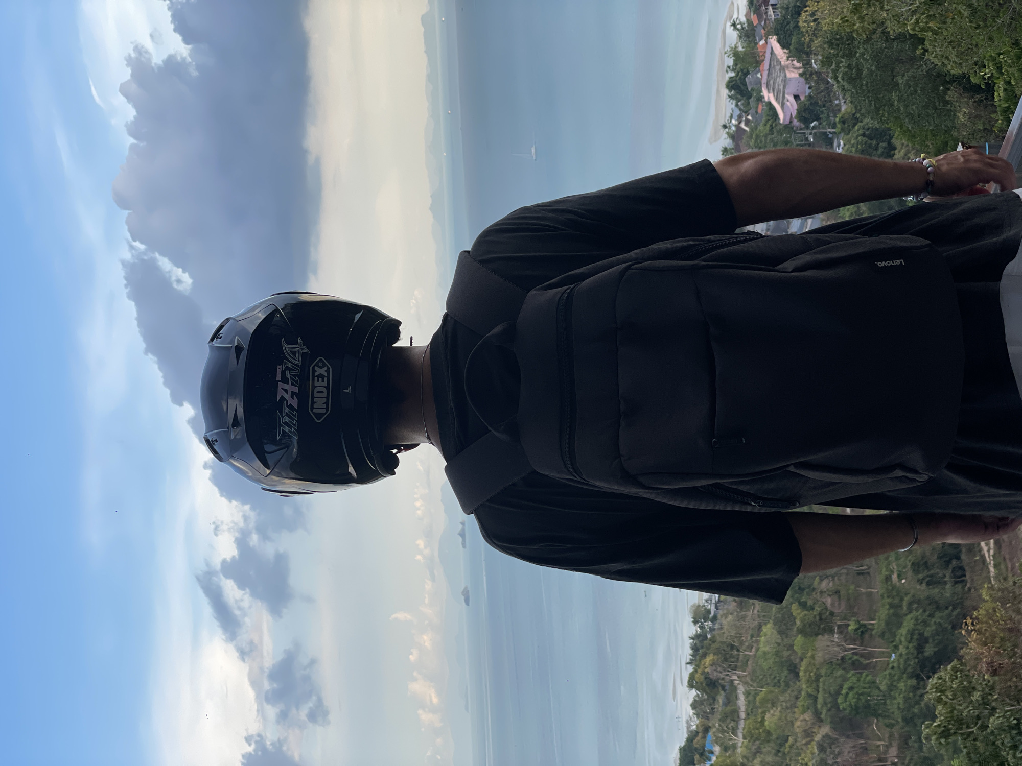 Helmeted visitor takes in coastal views at Thai seaside town