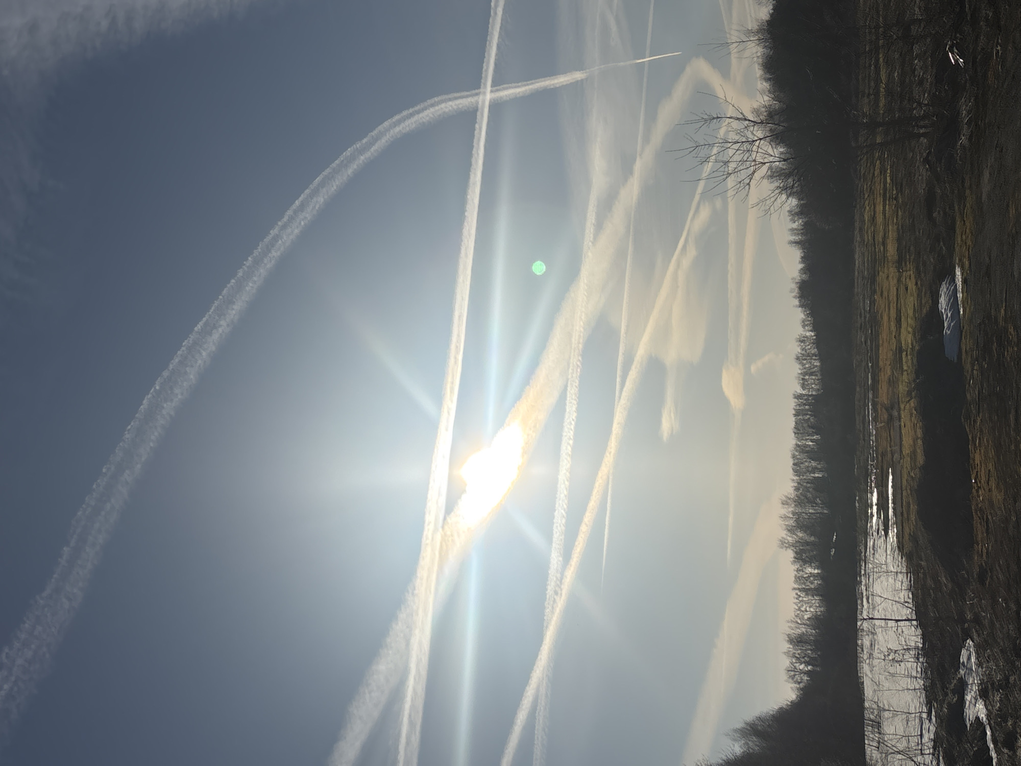 Multiple aircraft contrails create abstract sky pattern over Russia