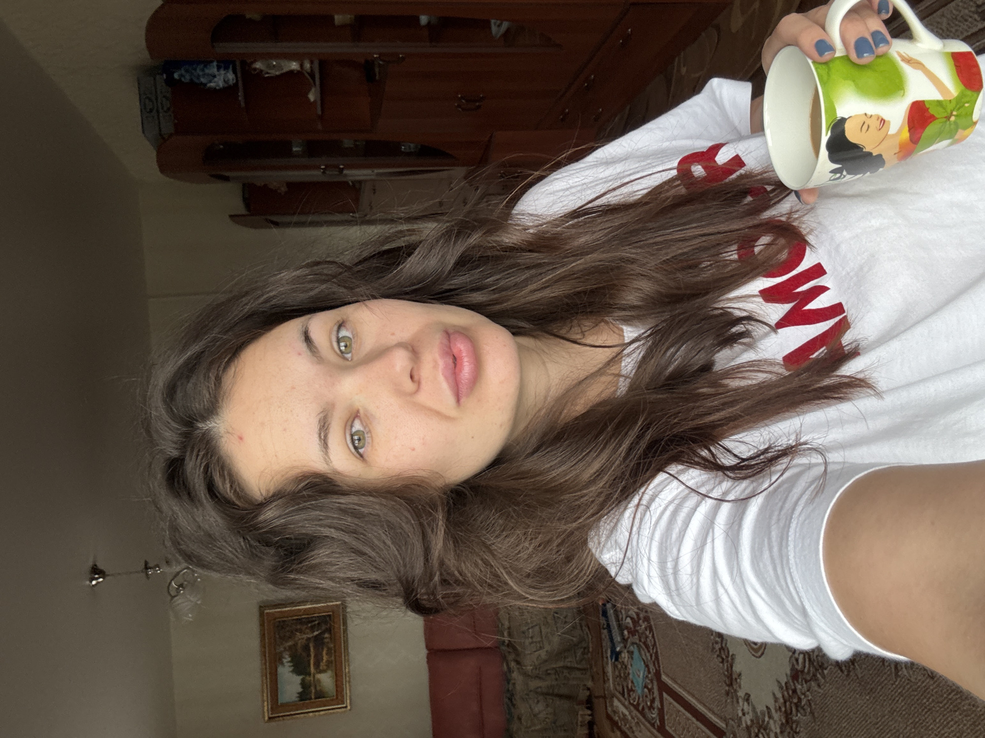 Woman drinks coffee indoors during heavy rainstorm in rural Russia