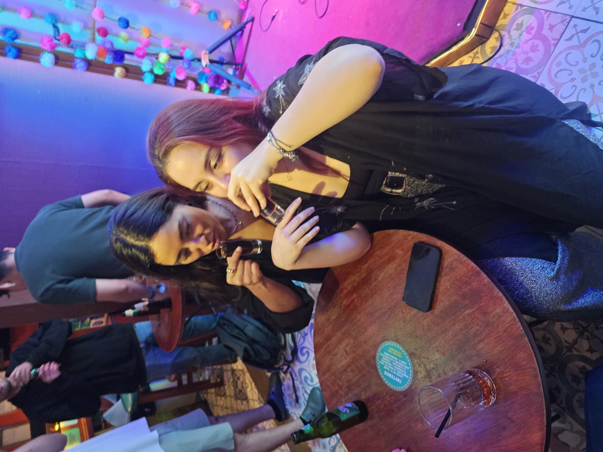 Women share drinks at morning gathering in Miraflores bar