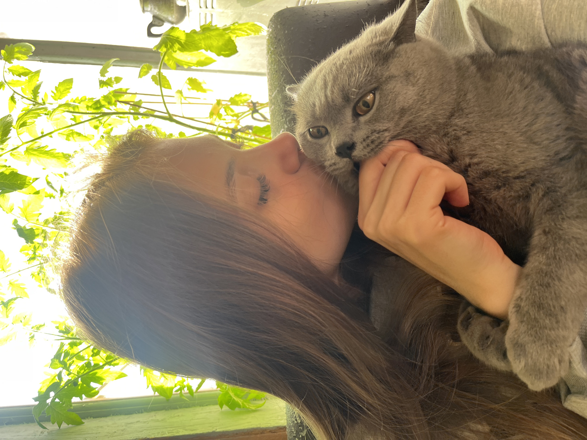 Woman and gray cat share tender moments in Russian village