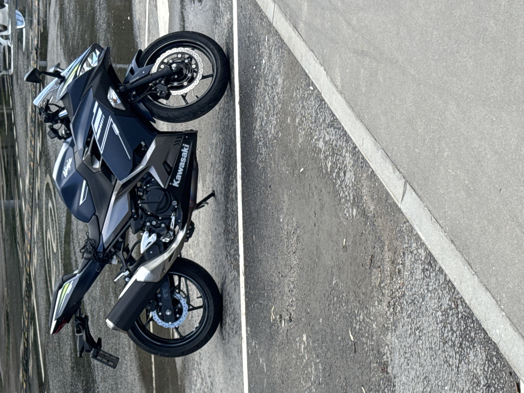 Street-level moments: a parked motorcycle, skyward glance, and elevator selfie