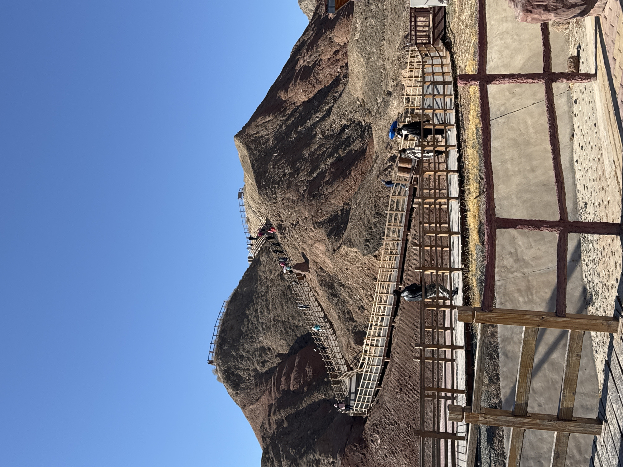 Tourists explore red mountain walkways in Nantai, China